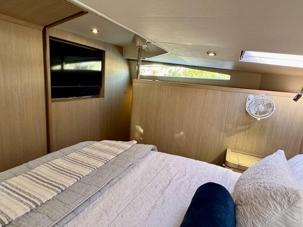 Luxurious cabin interior of 2022 Aquila 44 yacht with cozy bedding and modern amenities.