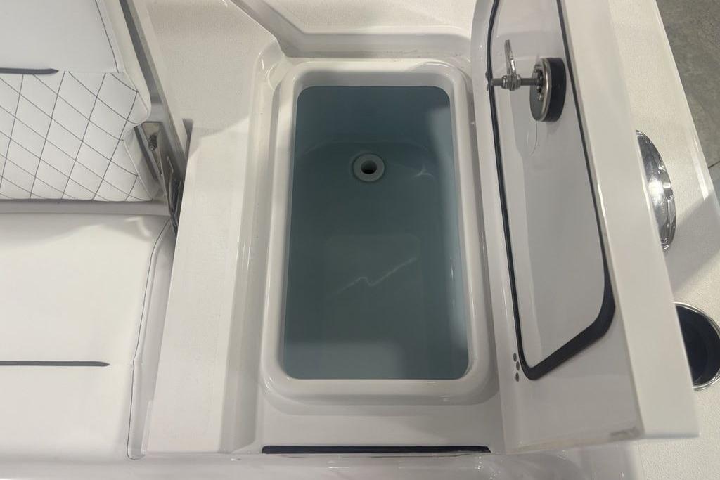 Livewell compartment in 2026 Sportsman Masters 227 boat, featuring a sleek design.