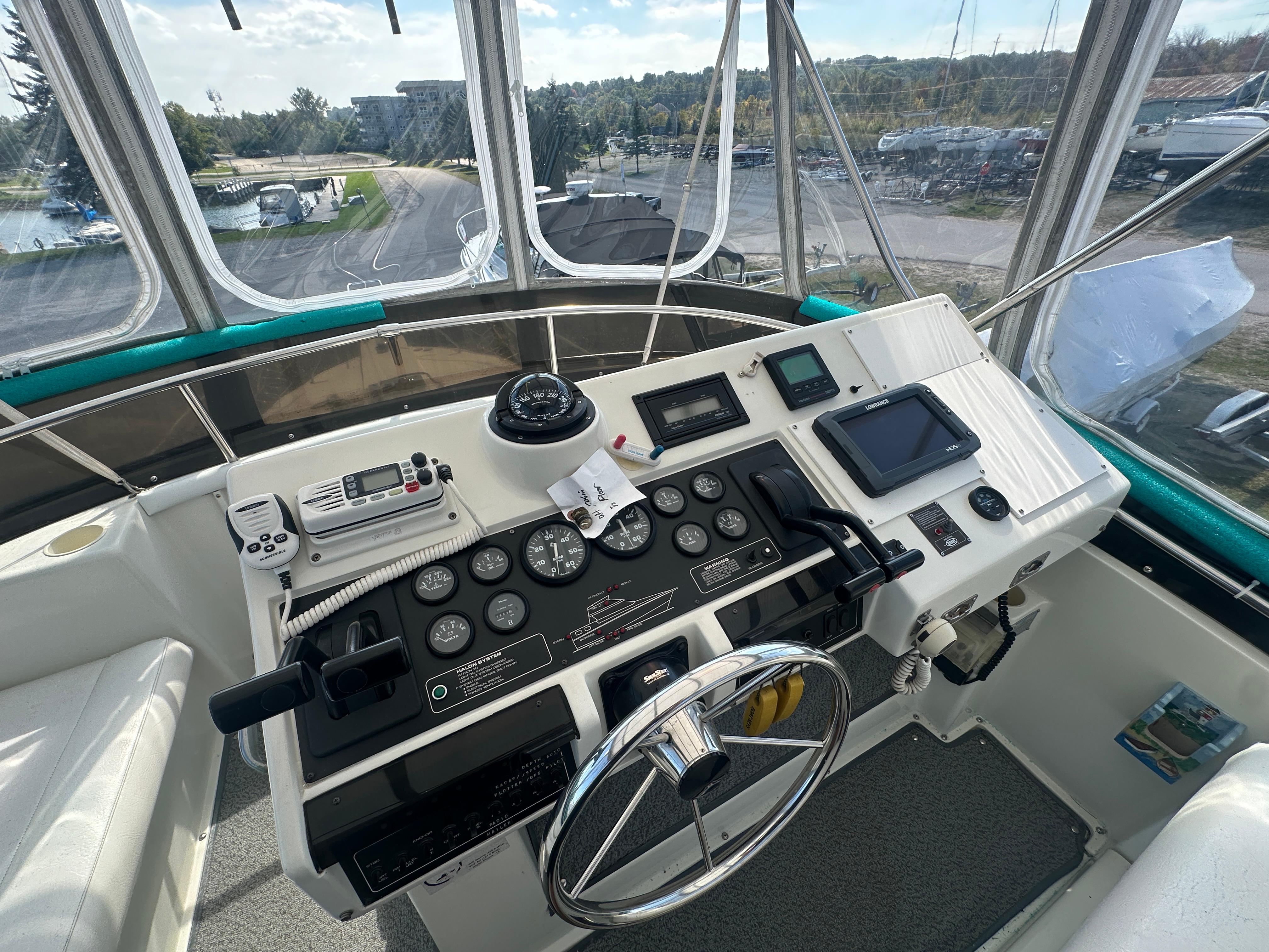 1994 Silverton 34 Aft Cabin Motor Yacht helm with navigation instruments and steering wheel.