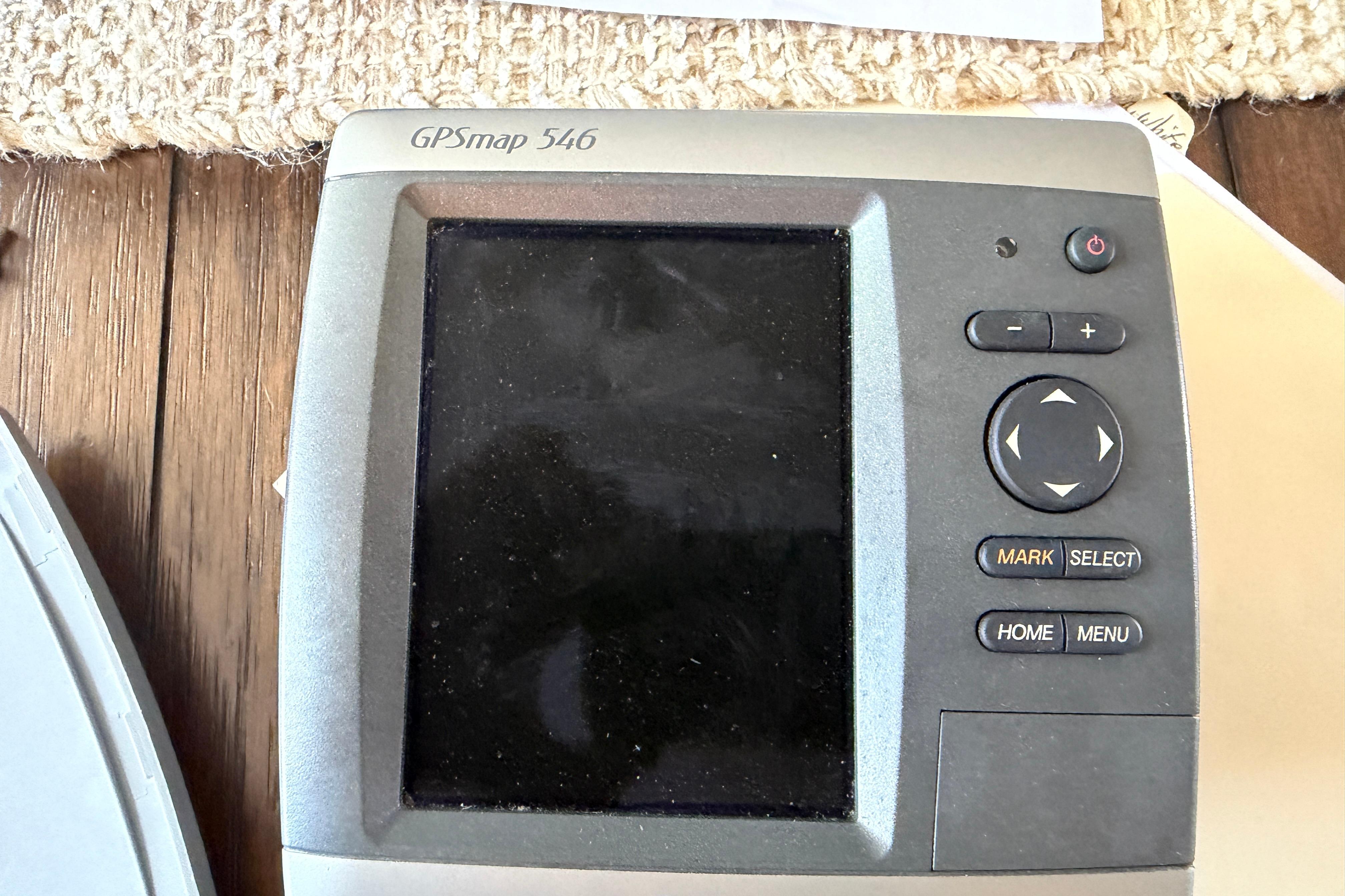 GPSmap 546 device on a 1987 Grady-White Seafarer 22 boat, featuring navigation controls.