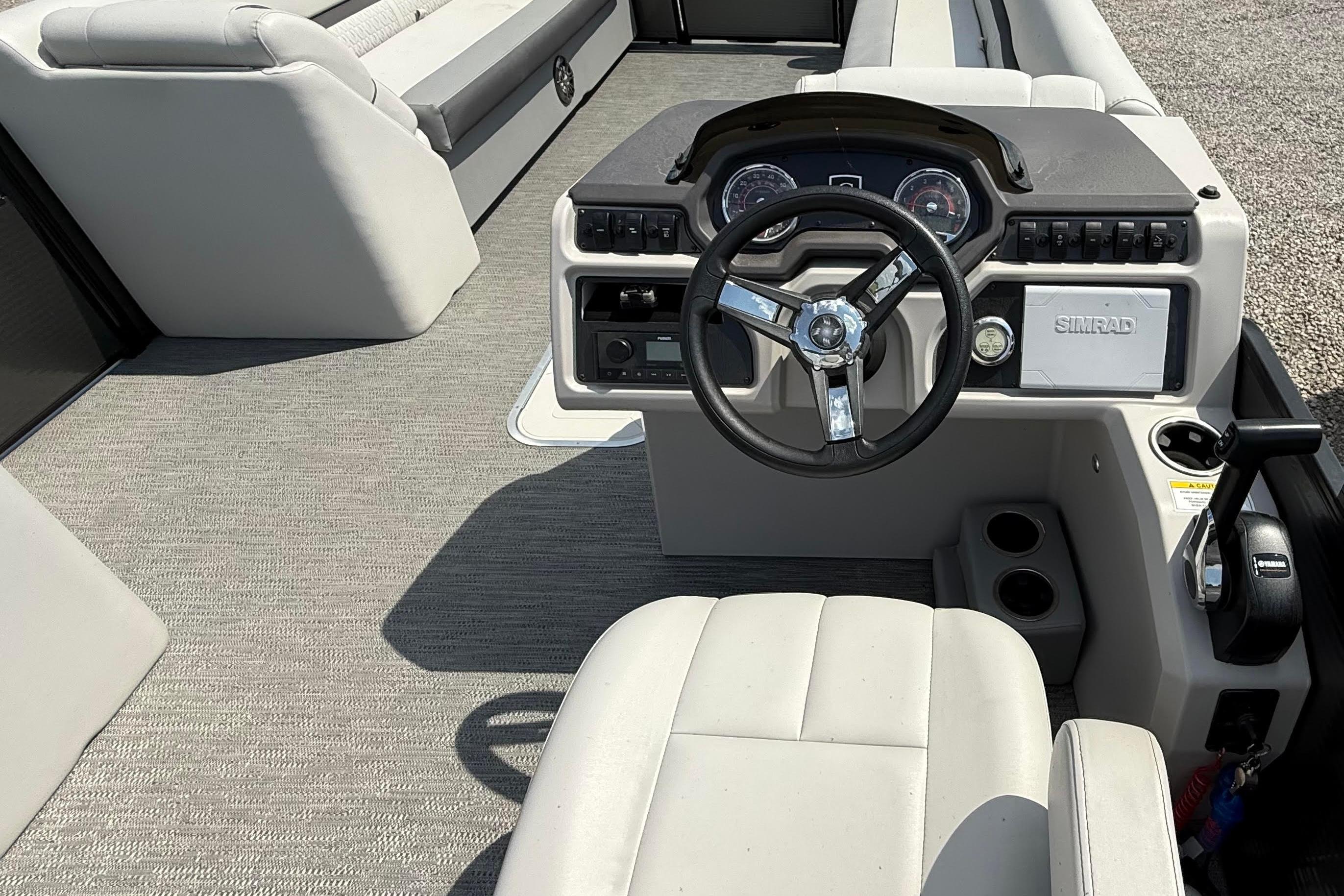 2022 Godfrey SWEETWATER 2486 boat interior with steering wheel and control panel.