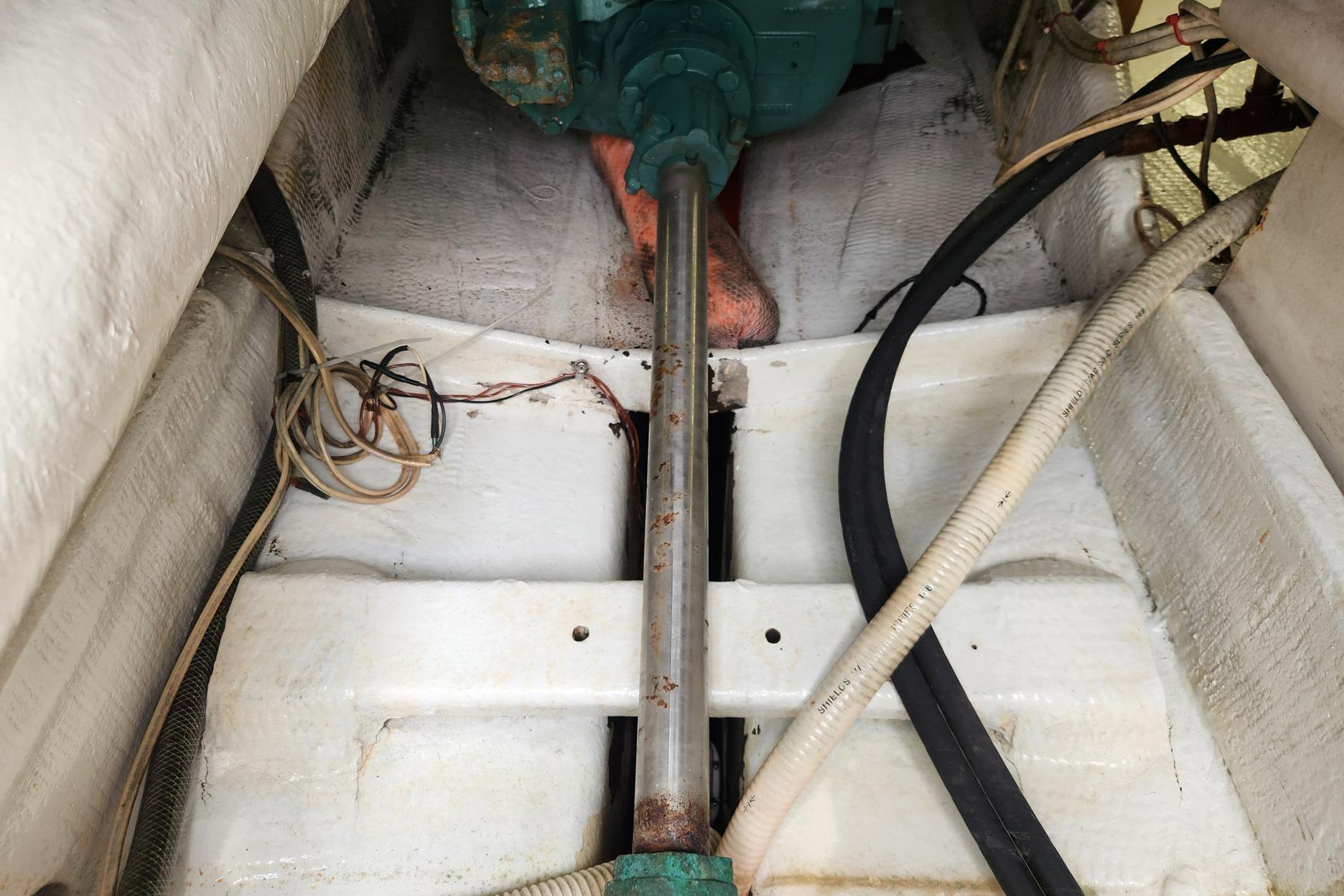 Engine compartment of 1987 Young Brothers Custom Sport Fish boat, showing shaft and wiring.