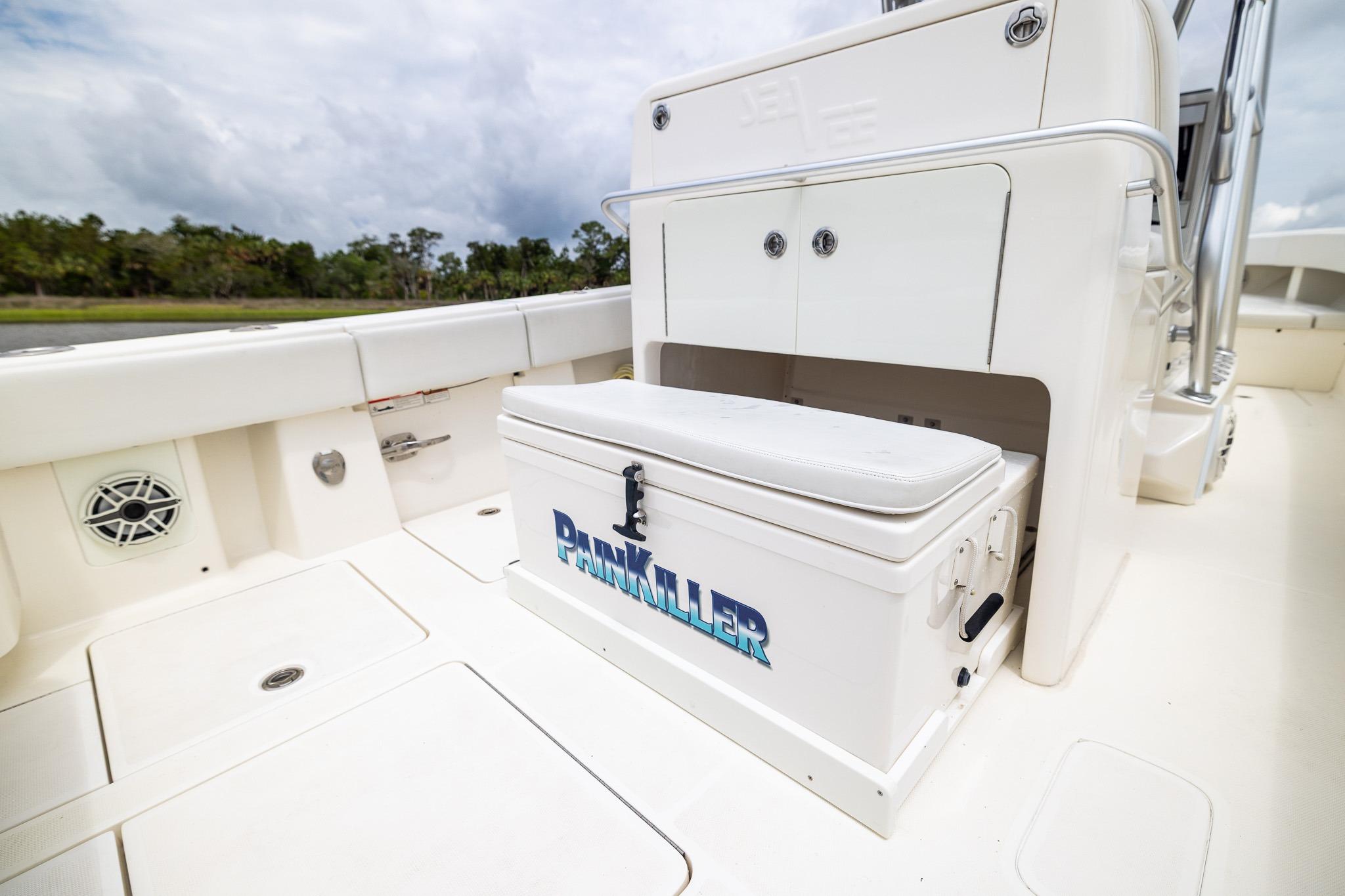 2019 SeaVee 322Z boat interior with storage and seating, featuring "Painkiller" cooler.