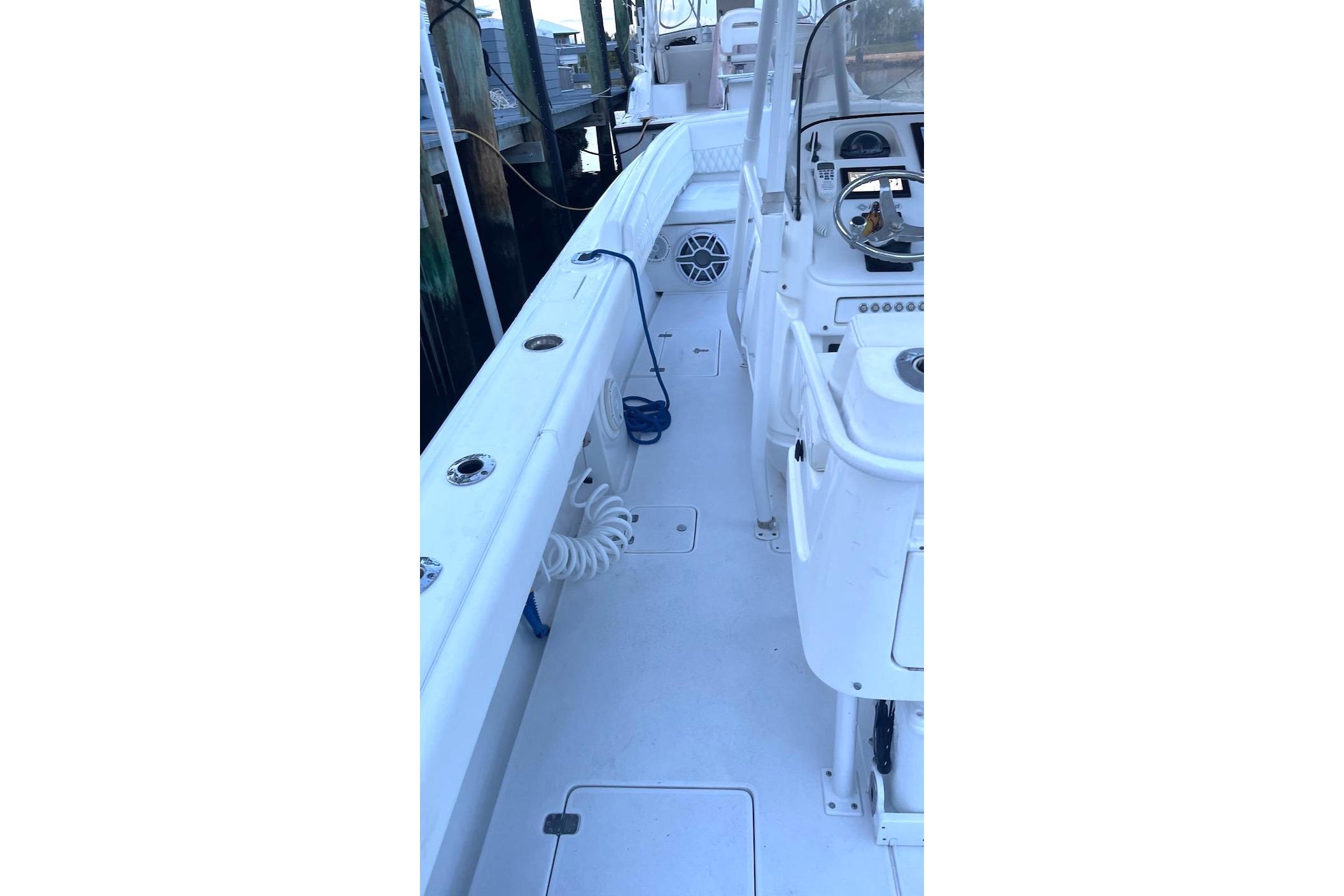 2002 Intrepid 323 Cuddy boat interior with white deck and seating area.