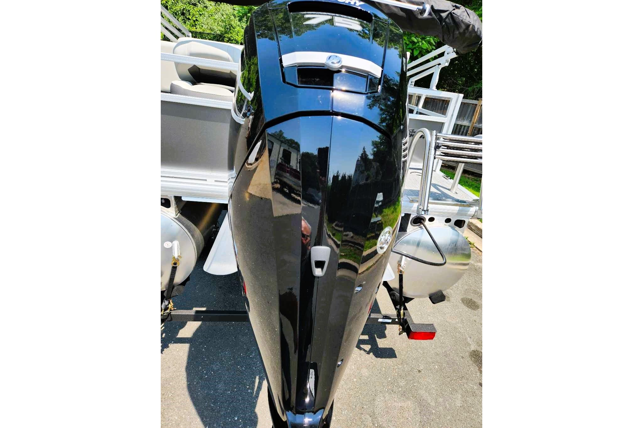 2026 Sun Tracker Bass Buggy 18 DLX pontoon boat with sleek black motor.