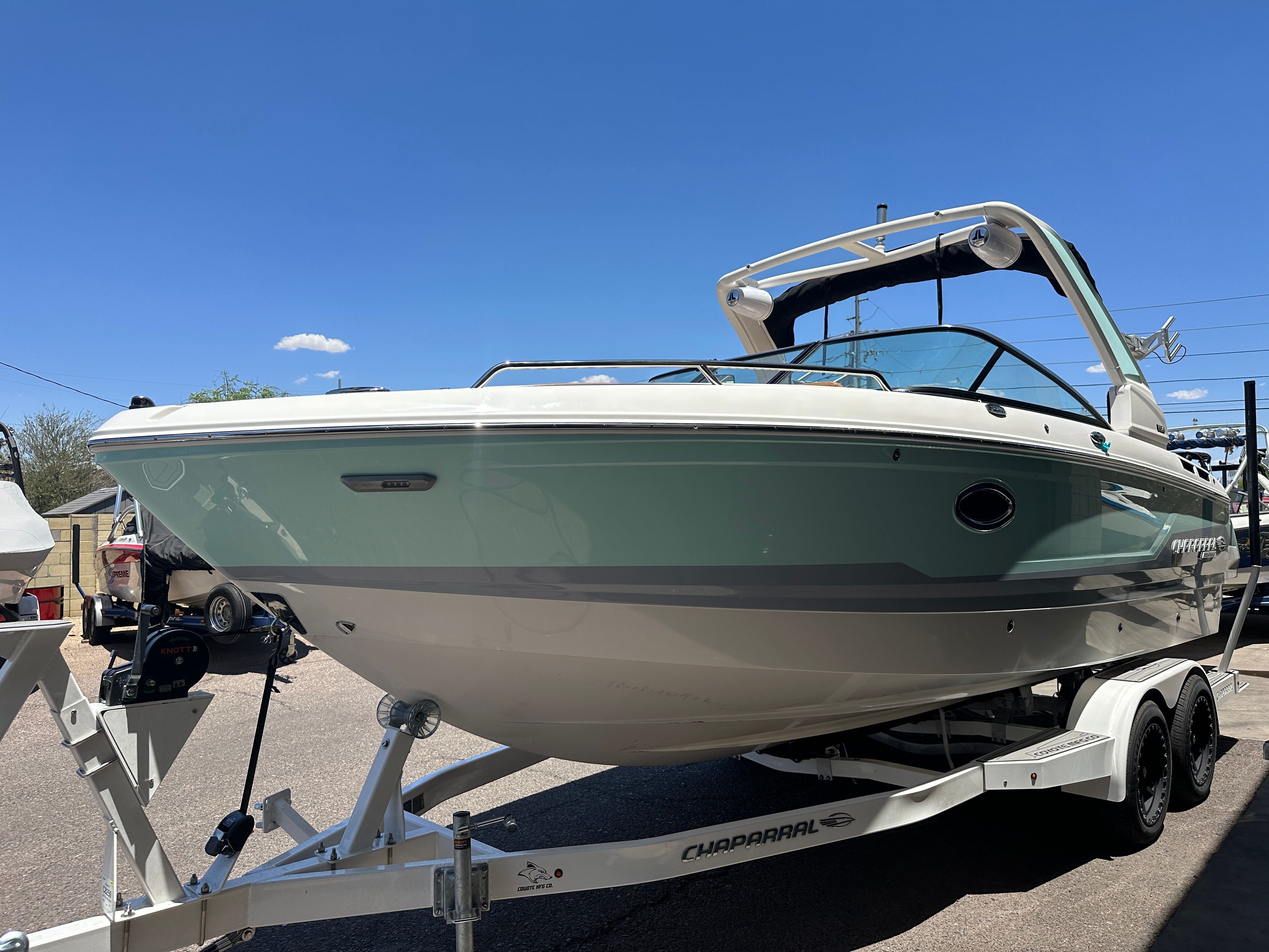A 2025 Chaparral 26 Surf boat on a trailer, ready for the water.
