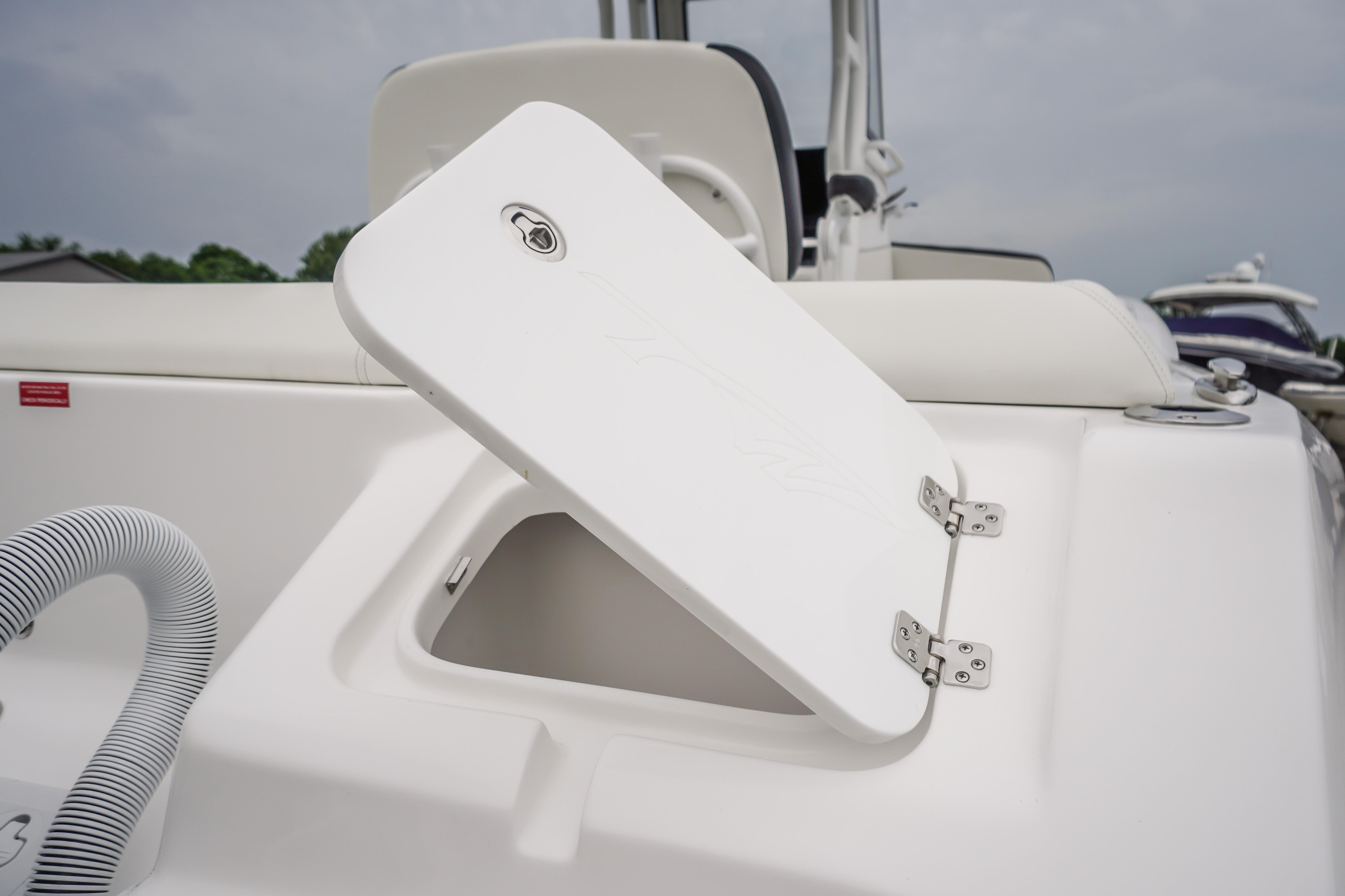 2026 Tidewater 232 SS boat storage compartment with open hatch, showcasing sleek design.