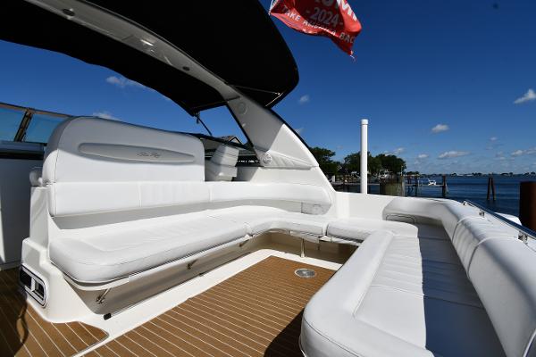 Spacious deck of 1997 Sea Ray 400 Sundancer yacht with white seating and scenic water view.