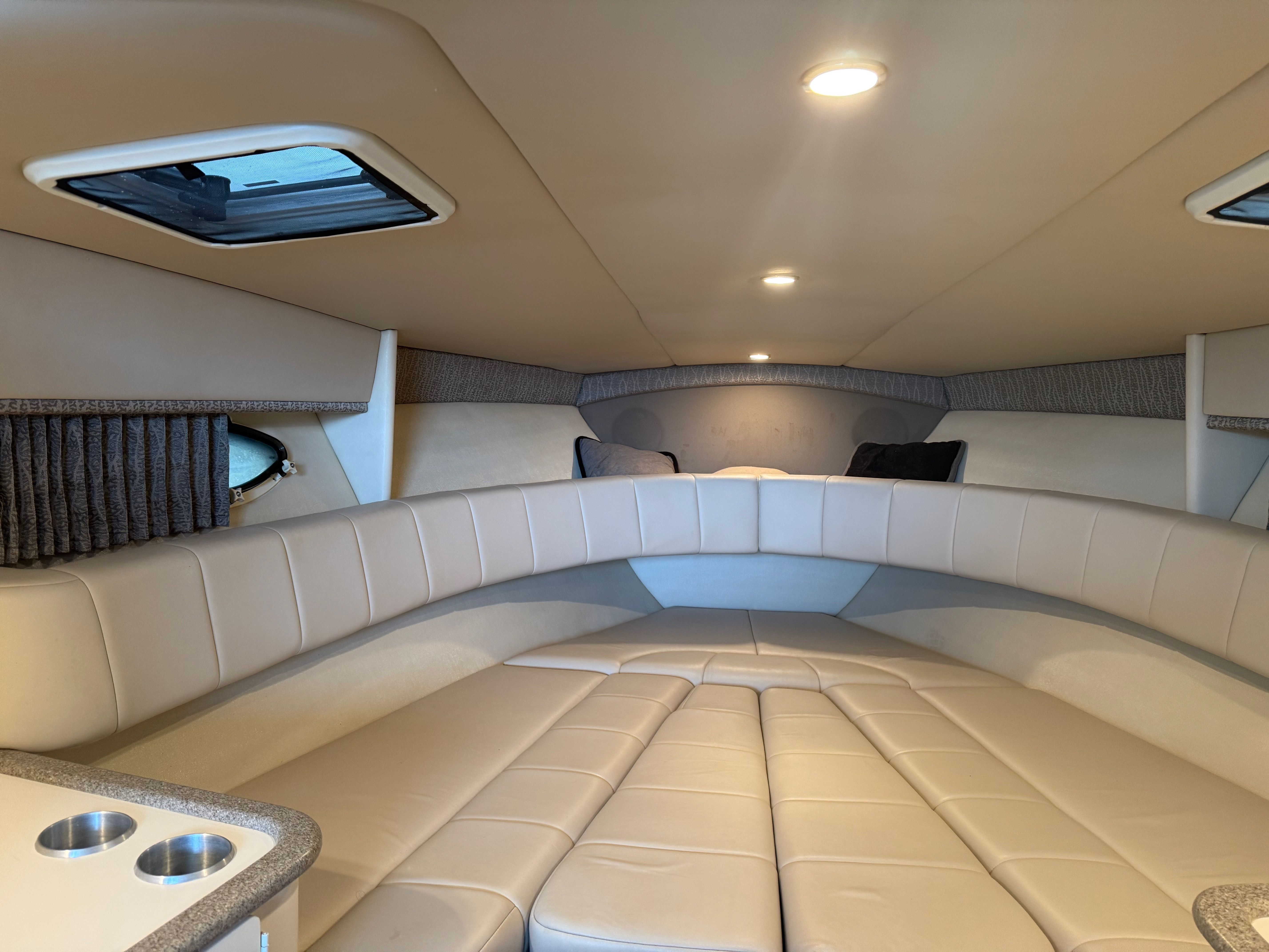 Interior of a 2001 Formula 330 Sun Sport yacht with cushioned seating.