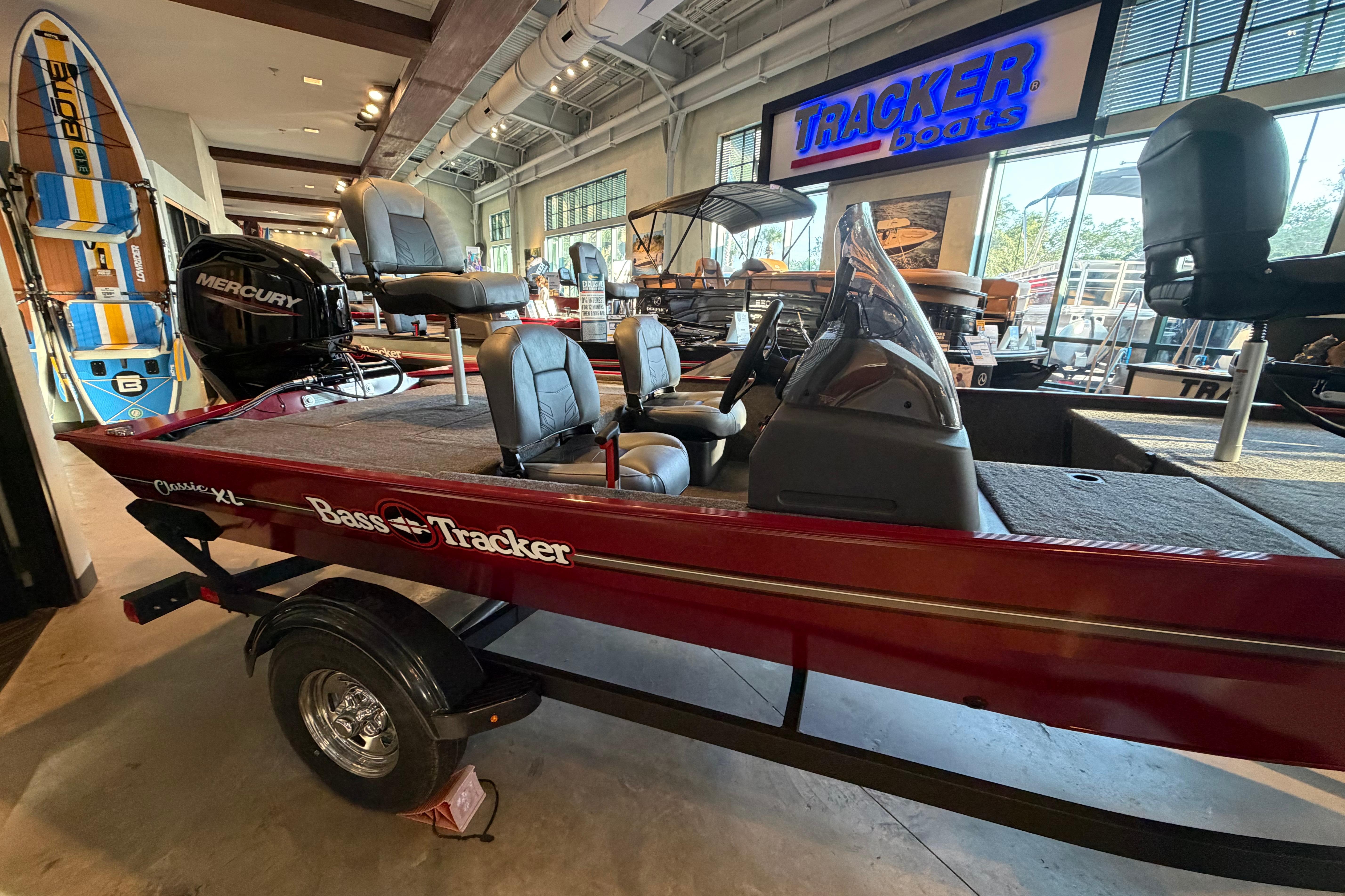 2026 Tracker Bass Tracker Classic XL boat displayed in showroom with Mercury engine.