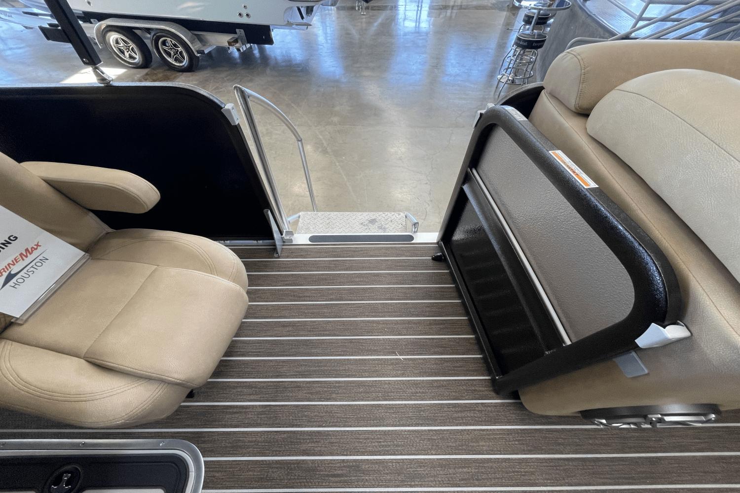 2023 Premier 250 Intrigue boat interior with beige seating and striped flooring.