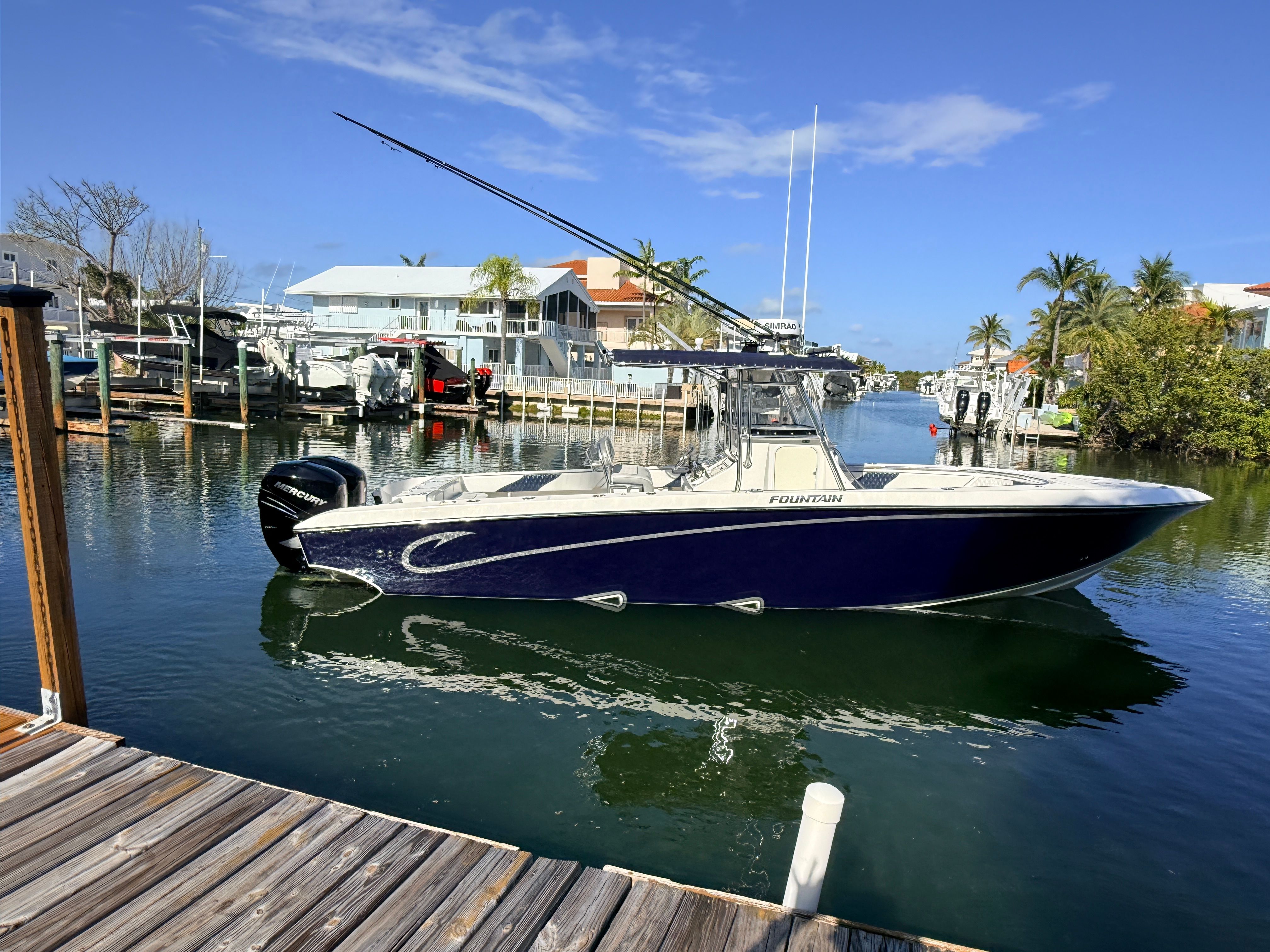 2007 Fountain 32 Center Console boat docked in marina.