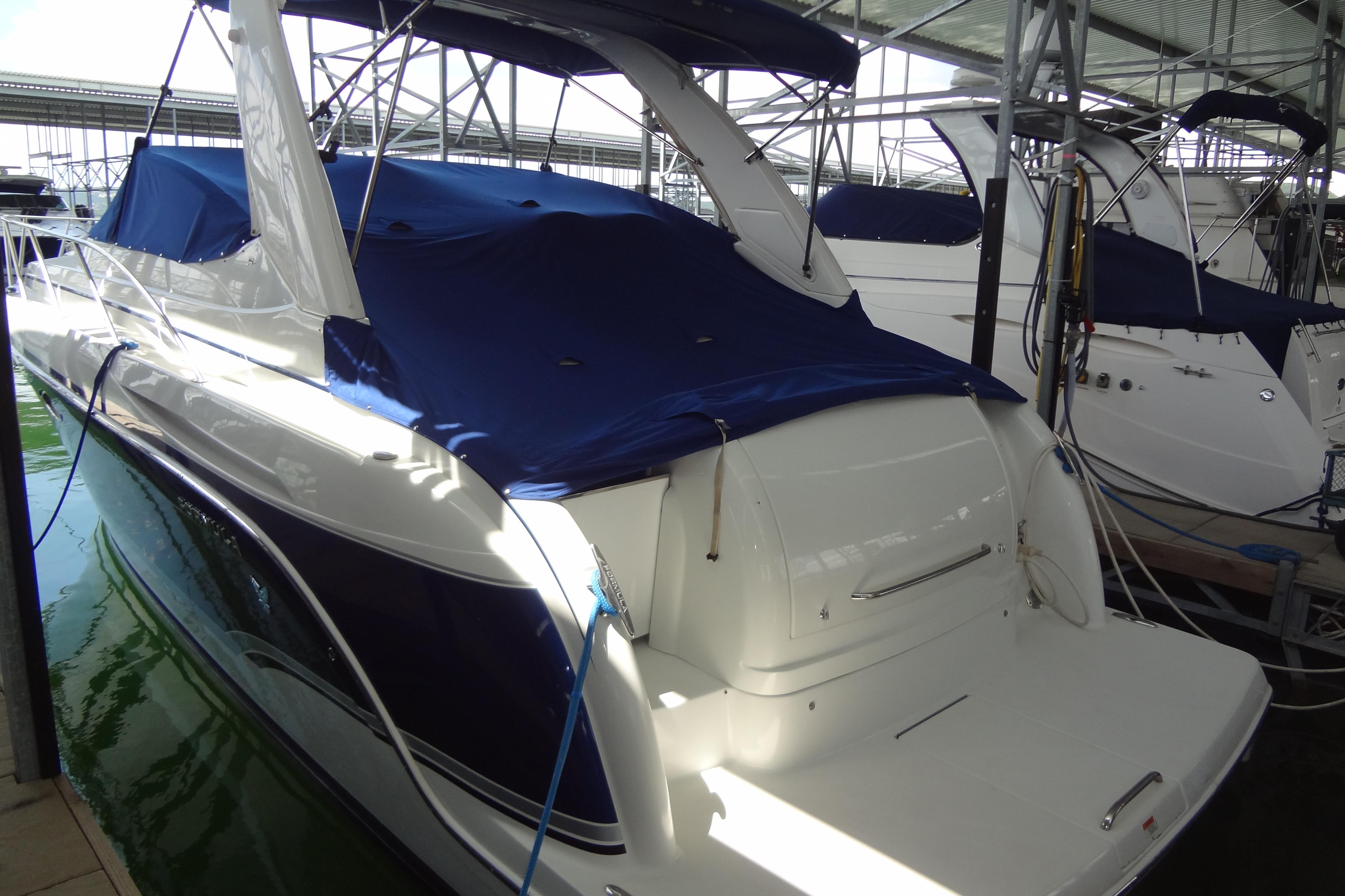 2007 Formula 34 Performance Cruiser docked, featuring blue covers and sleek design.
