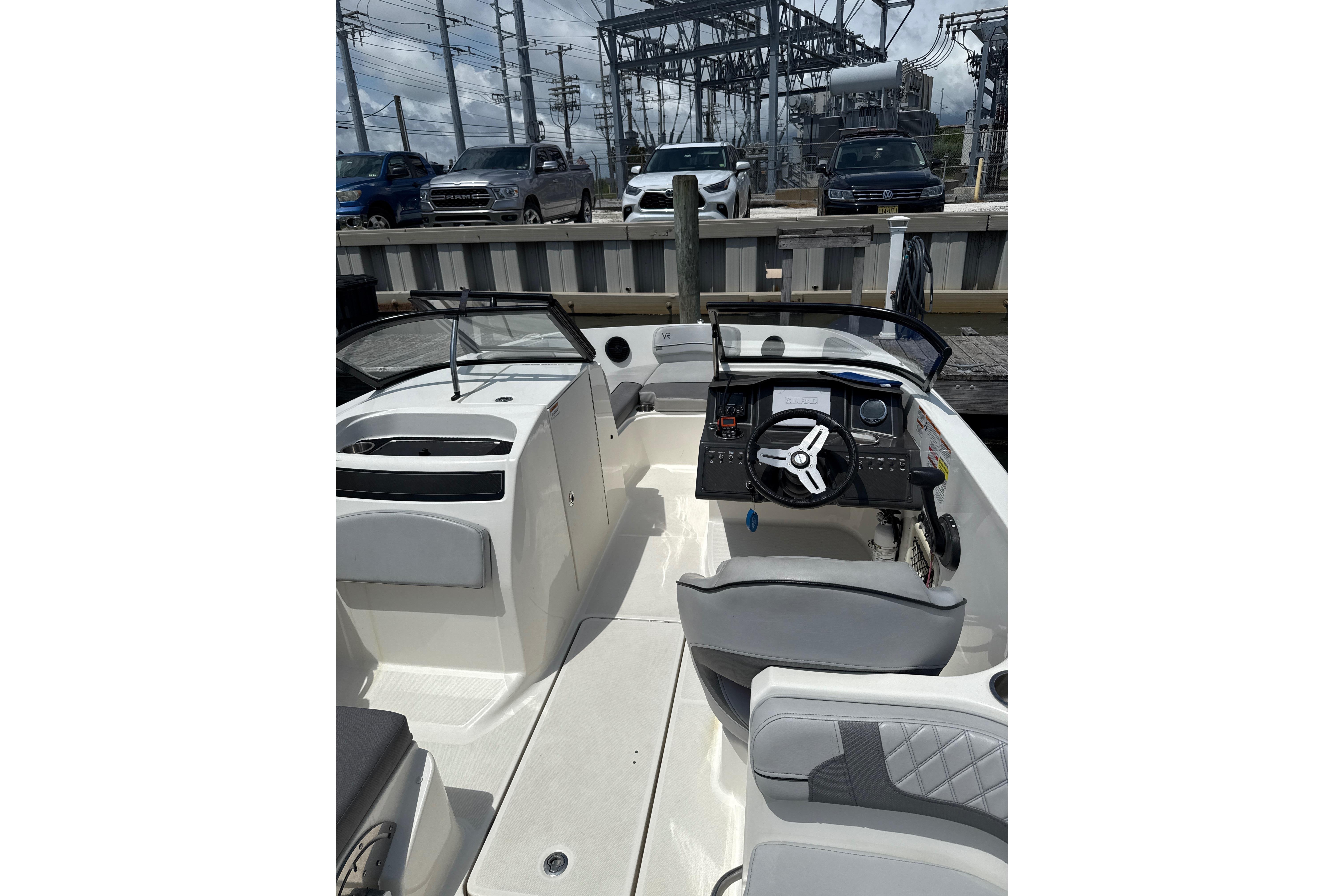 2023 Bayliner VR6 Bowrider OB interior with steering wheel and seating.