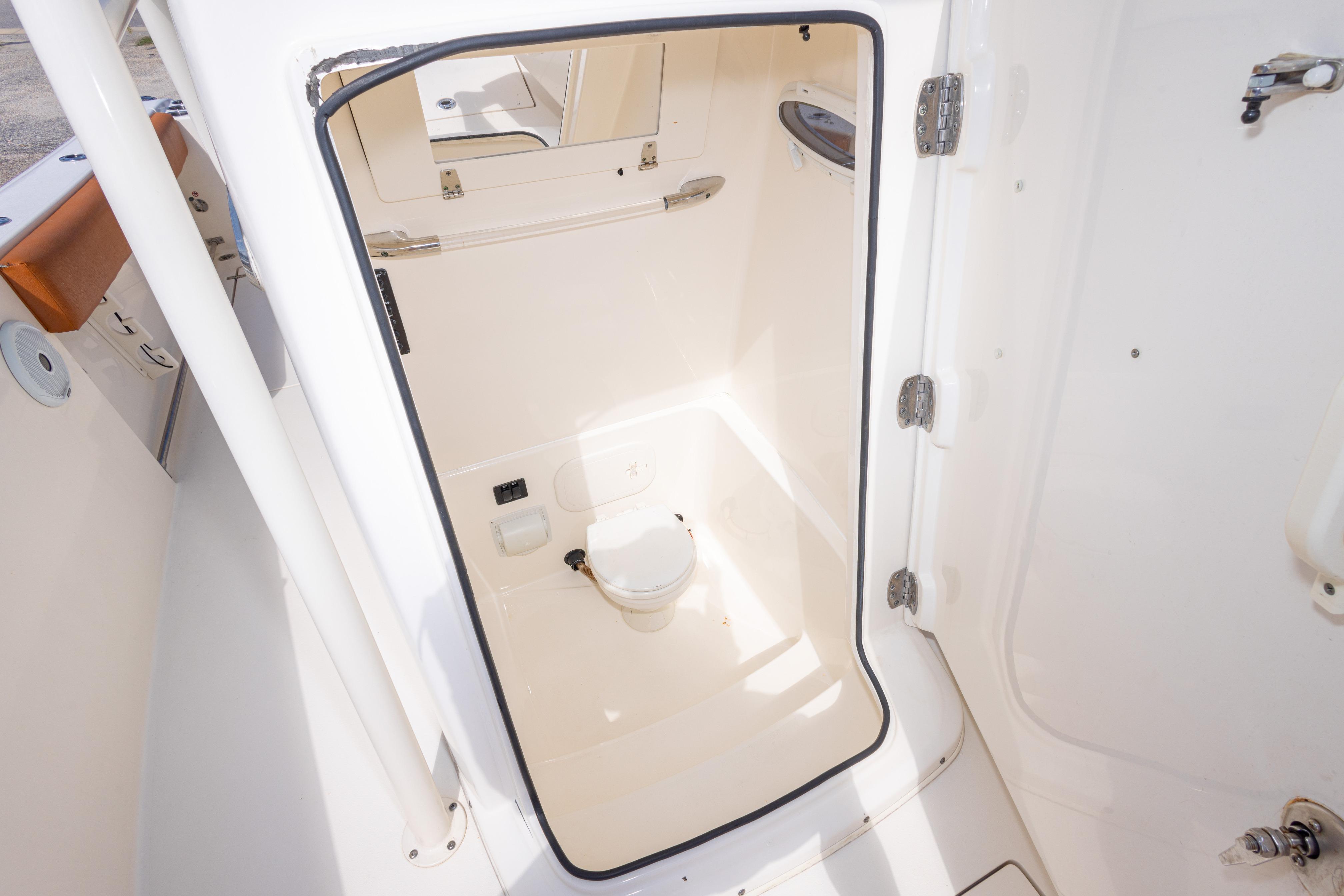 2017 Cobia 261 Center Console boat interior with compact marine toilet.