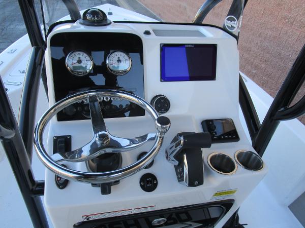 2025 Sea Pro 230 Bay boat dashboard with steering wheel and navigation controls.