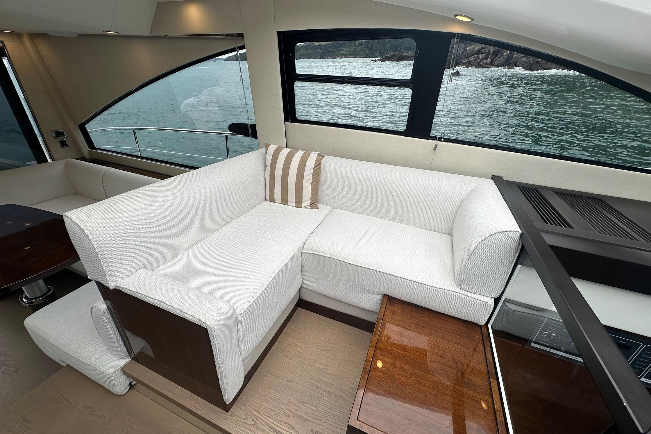 Luxurious interior of 2022 Fairline Targa 50 GT yacht with elegant seating and ocean view.