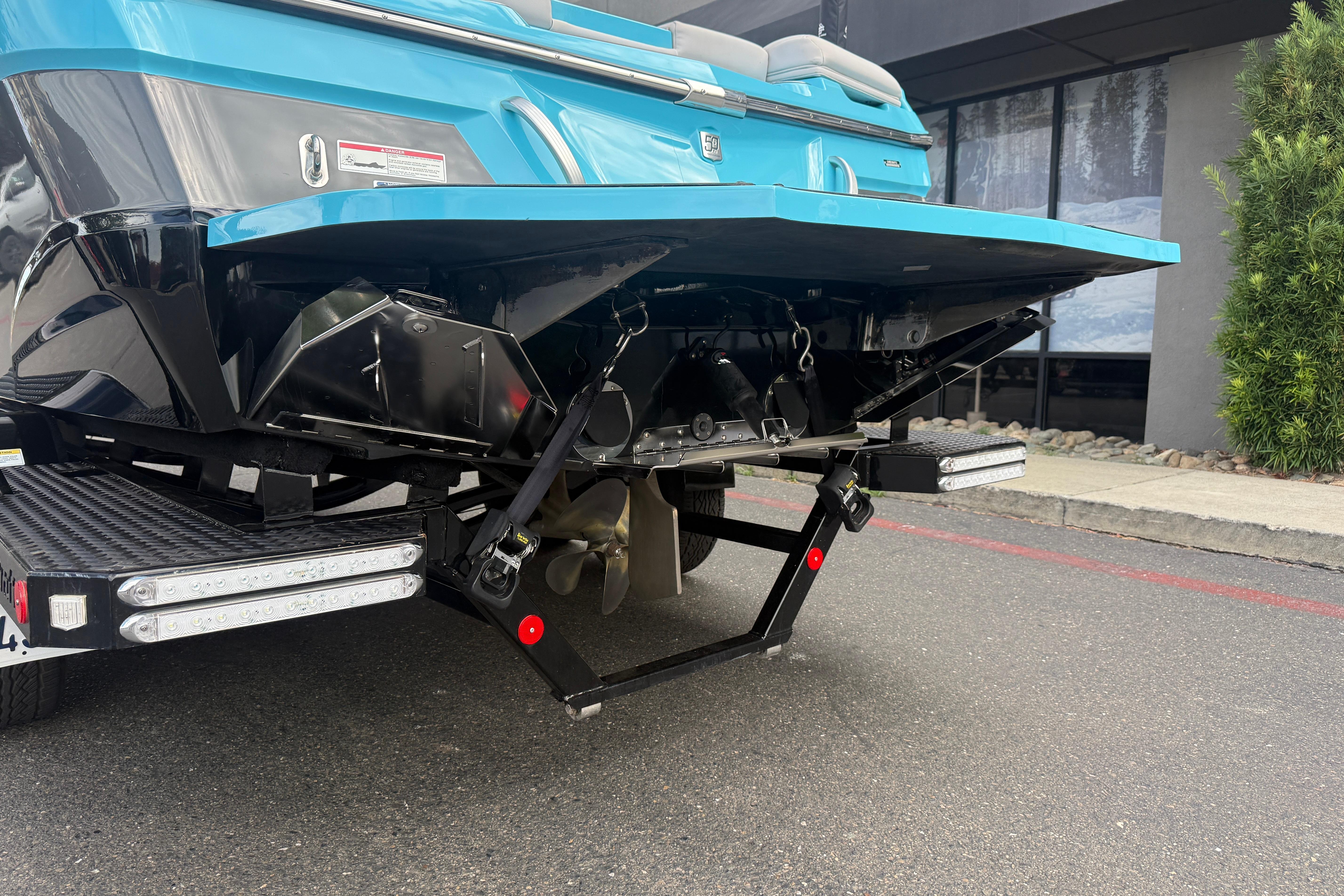2018 MasterCraft XT21 boat rear view, showcasing propeller and trailer details.