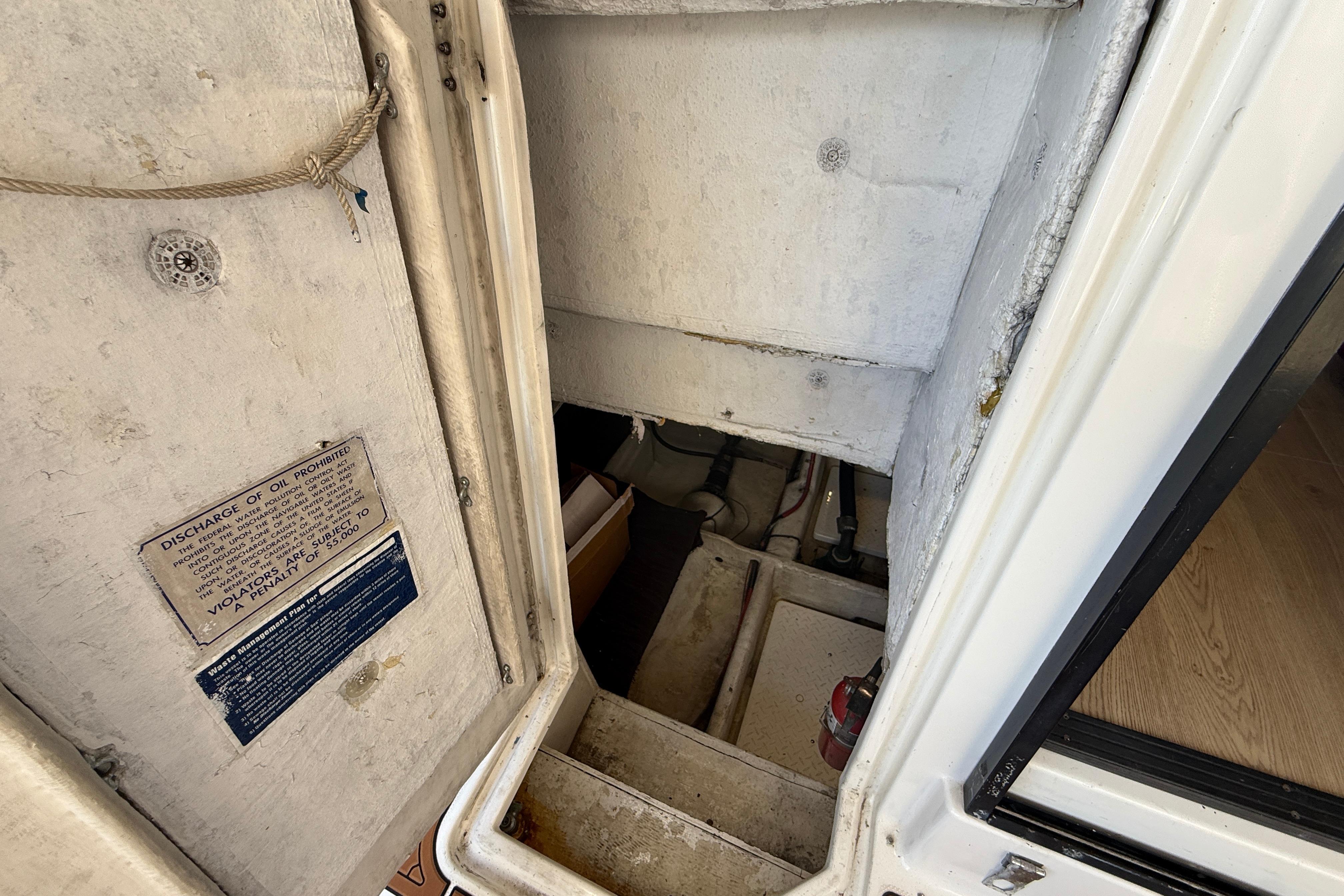 1997 Bayliner 3988 Command Bridge Motoryacht engine room access with safety notice.