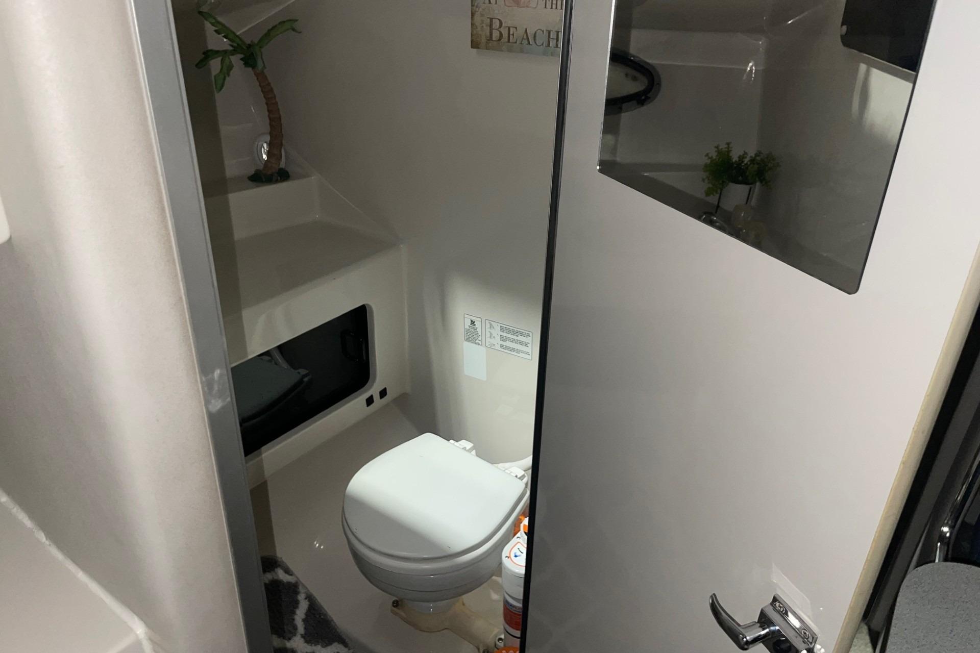 1992 Chaparral Signature 30 boat bathroom interior with toilet and decor.