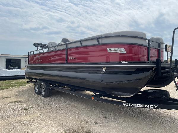2023 Regency 250DL3 pontoon boat on trailer, red and black design, parked outdoors.
