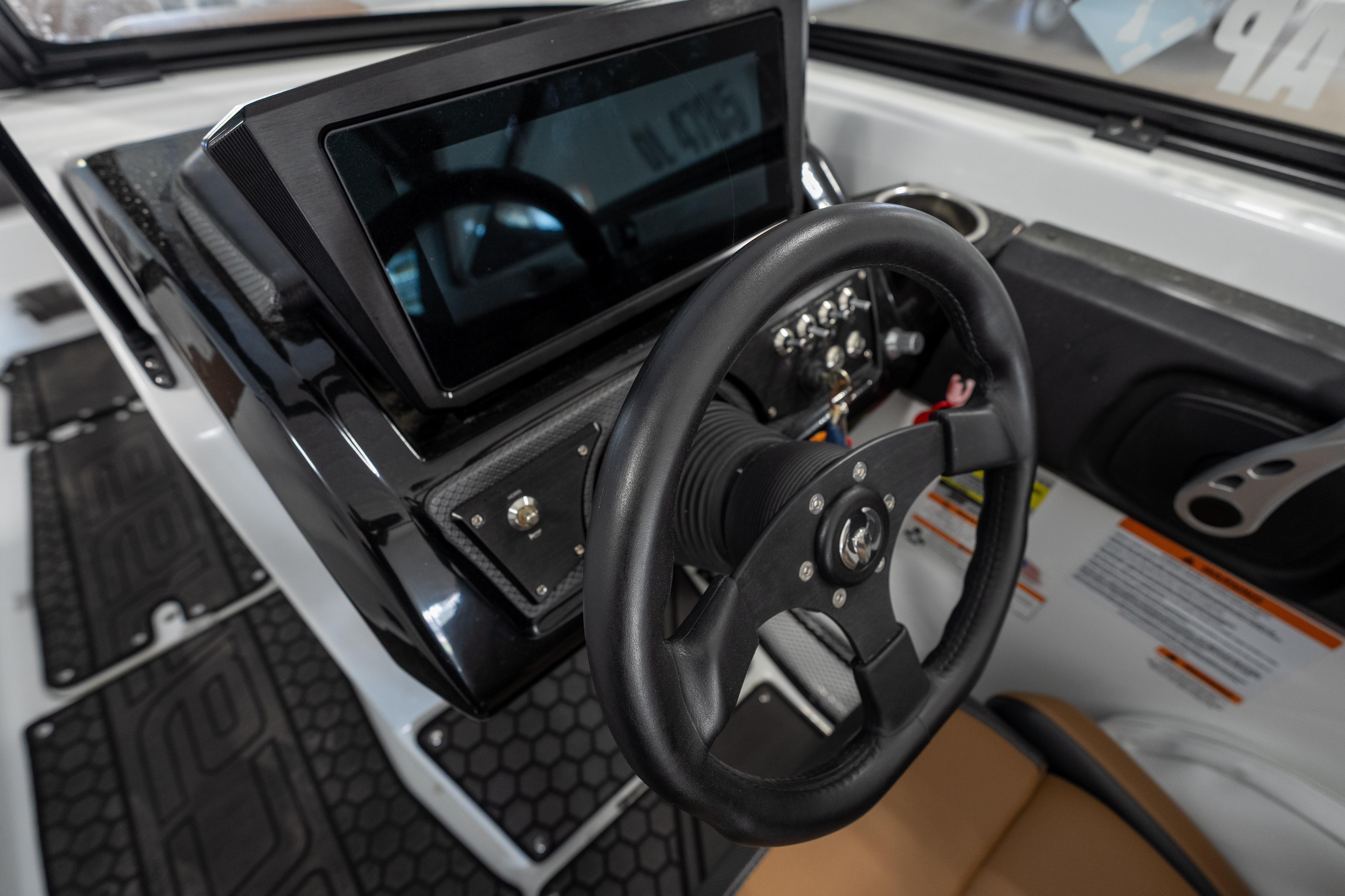 Steering console of 2023 Scarab 255 ID boat with touchscreen display.