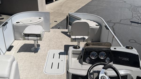 2023 SunCatcher Select 322FC boat interior with steering console and seating.