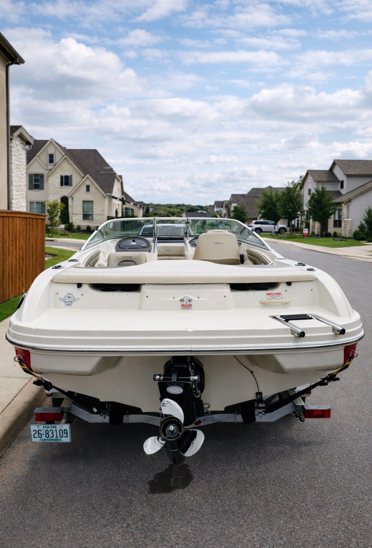 2005 Sea Ray 200 Sport boat on street in residential area.
