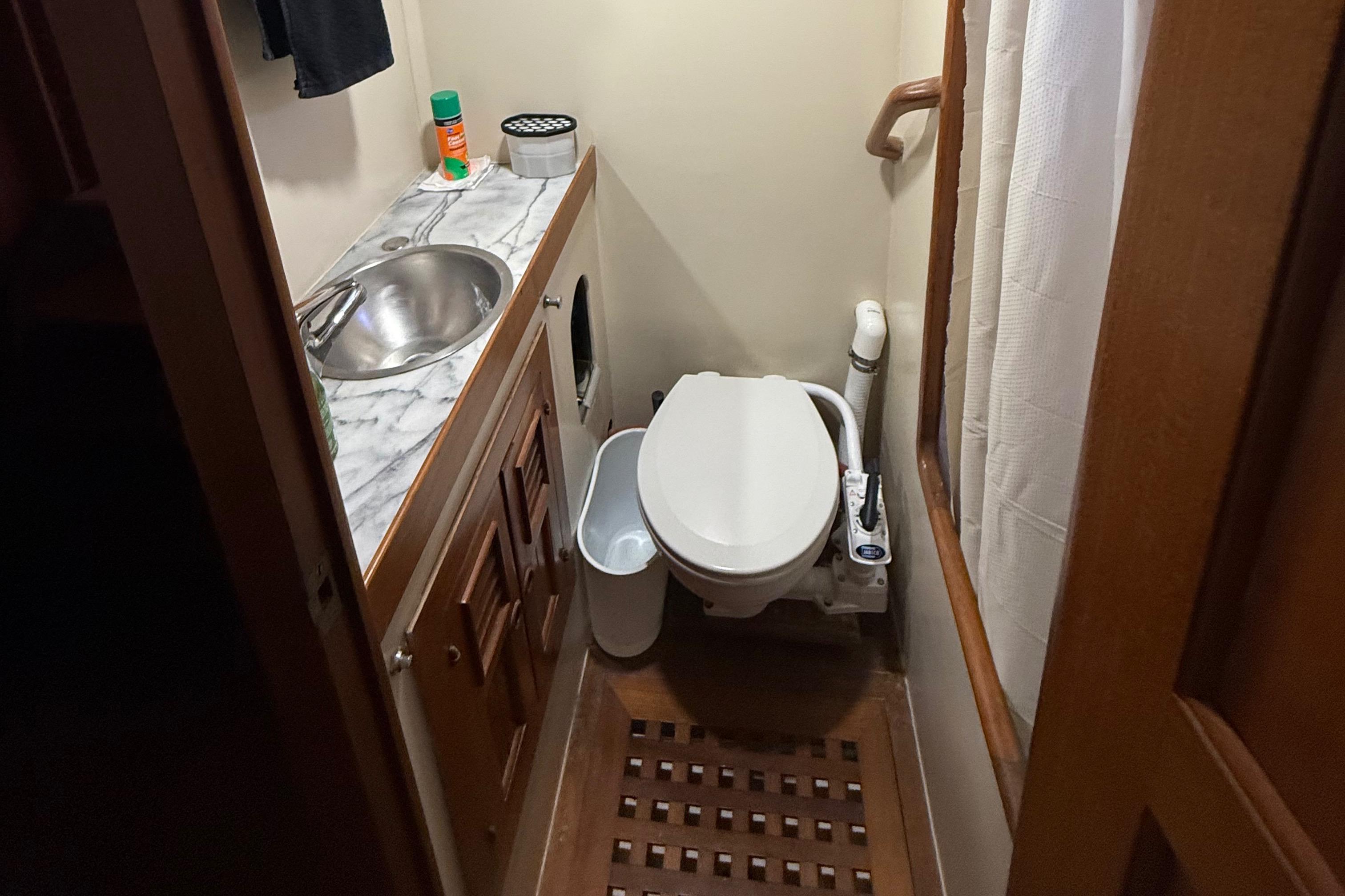 Bathroom interior of a 1978 DeFever 39 yacht with sink and toilet.