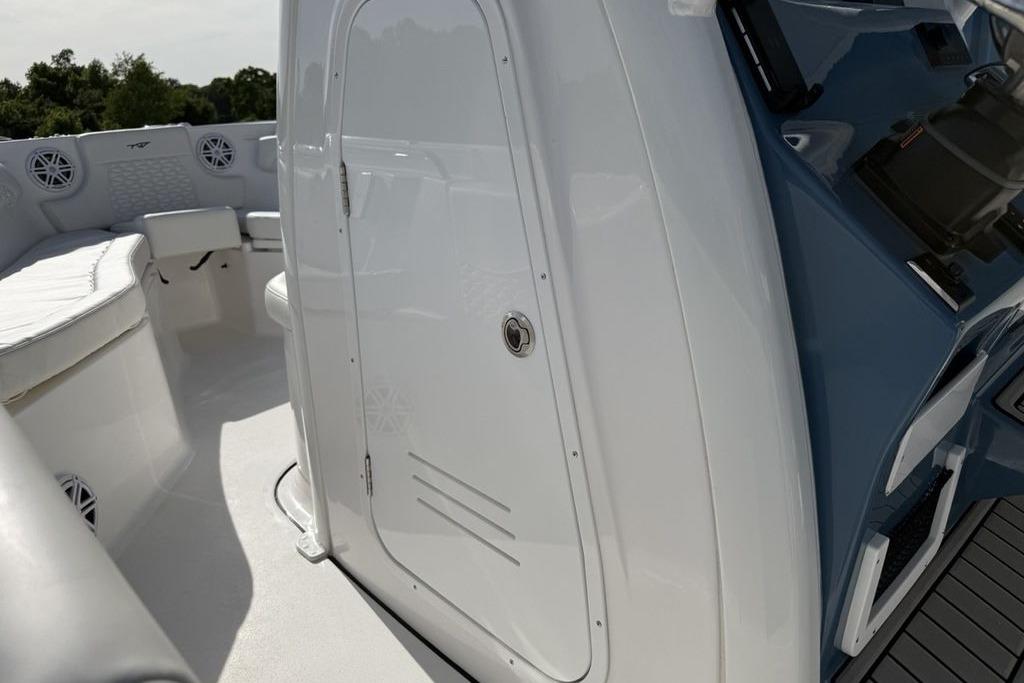 2026 Tidewater 232 LXF boat interior with seating and storage compartment.
