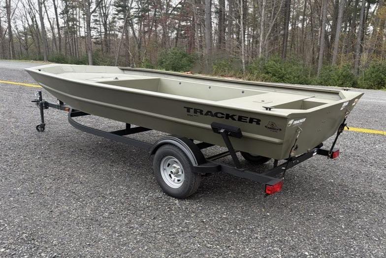 2026 Tracker Grizzly 1754 Utility boat on trailer, parked on gravel road.