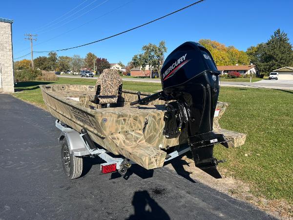 2025 Lowe Roughneck 1760 boat with Mercury engine on trailer, parked outdoors.