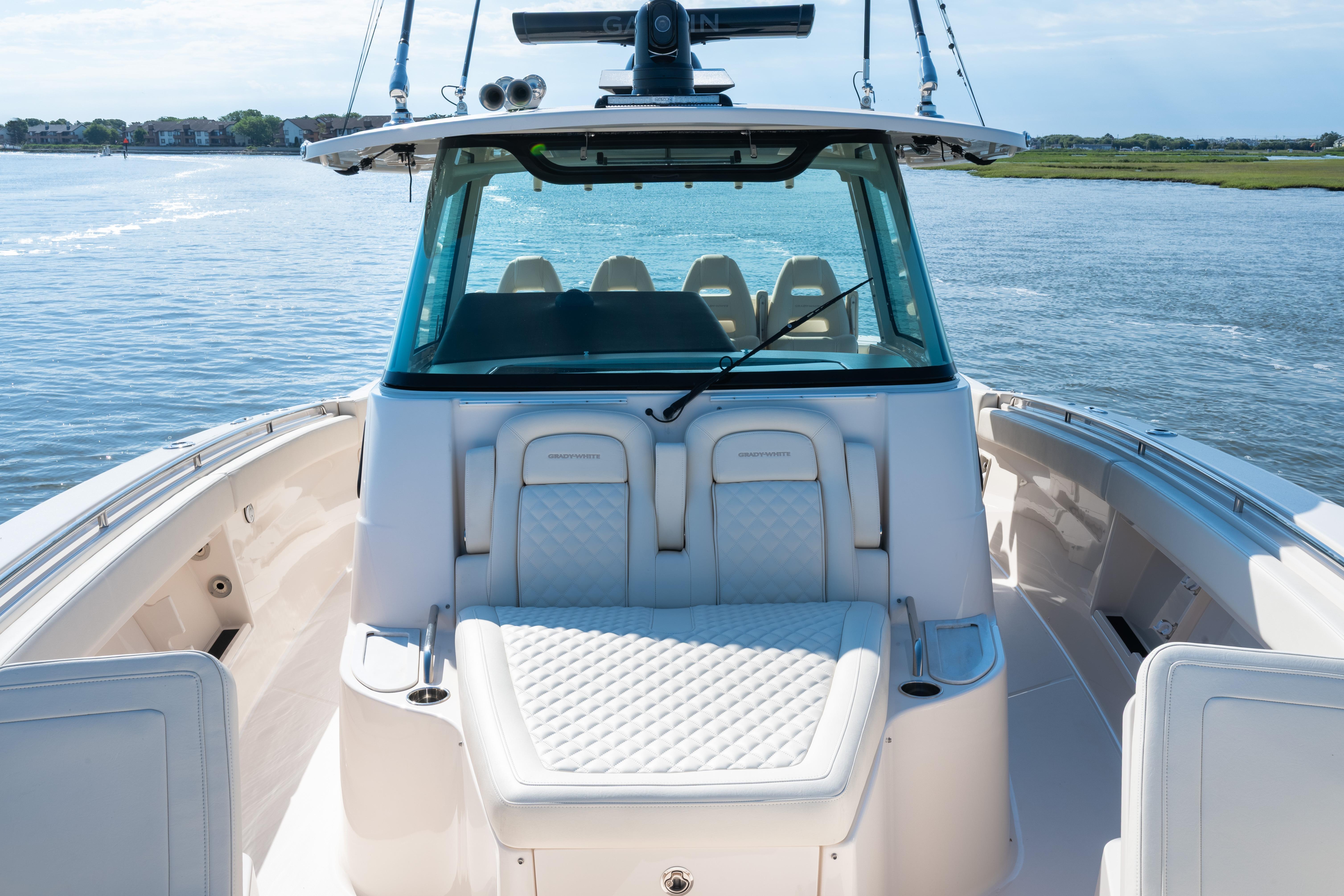 2025 Grady-White Canyon 386 boat interior with luxurious seating on calm water.