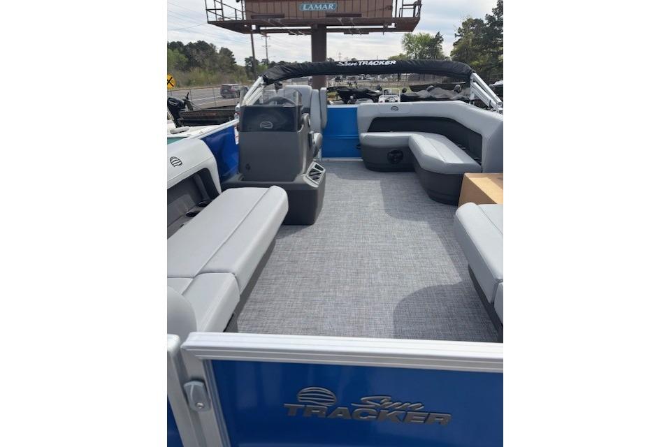2026 Sun Tracker Party Barge 16 DLX interior with gray seating and blue accents.