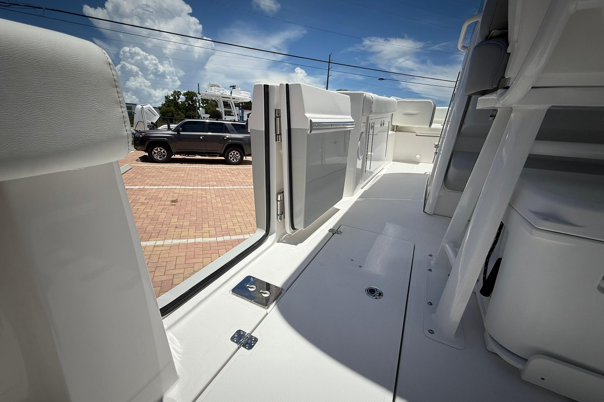 2026 Edgewater 250CC boat interior with open door, showcasing sleek design and spacious layout.