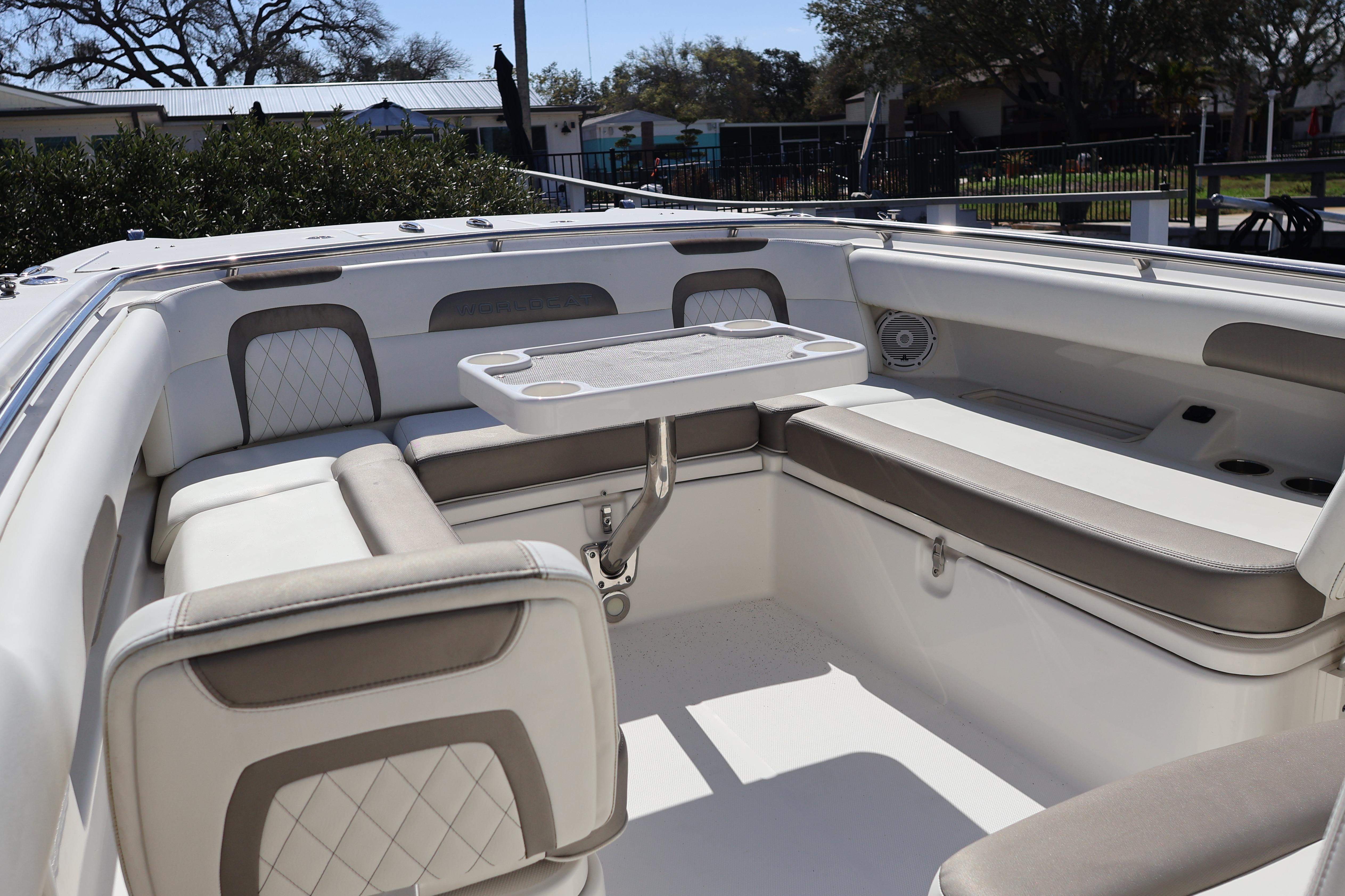 2022 World Cat 280 CC-X boat interior with cushioned seating and table.