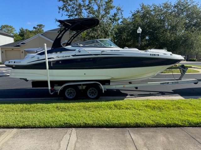2018 Hurricane SunDeck 2400 IO on a trailer in a residential area.