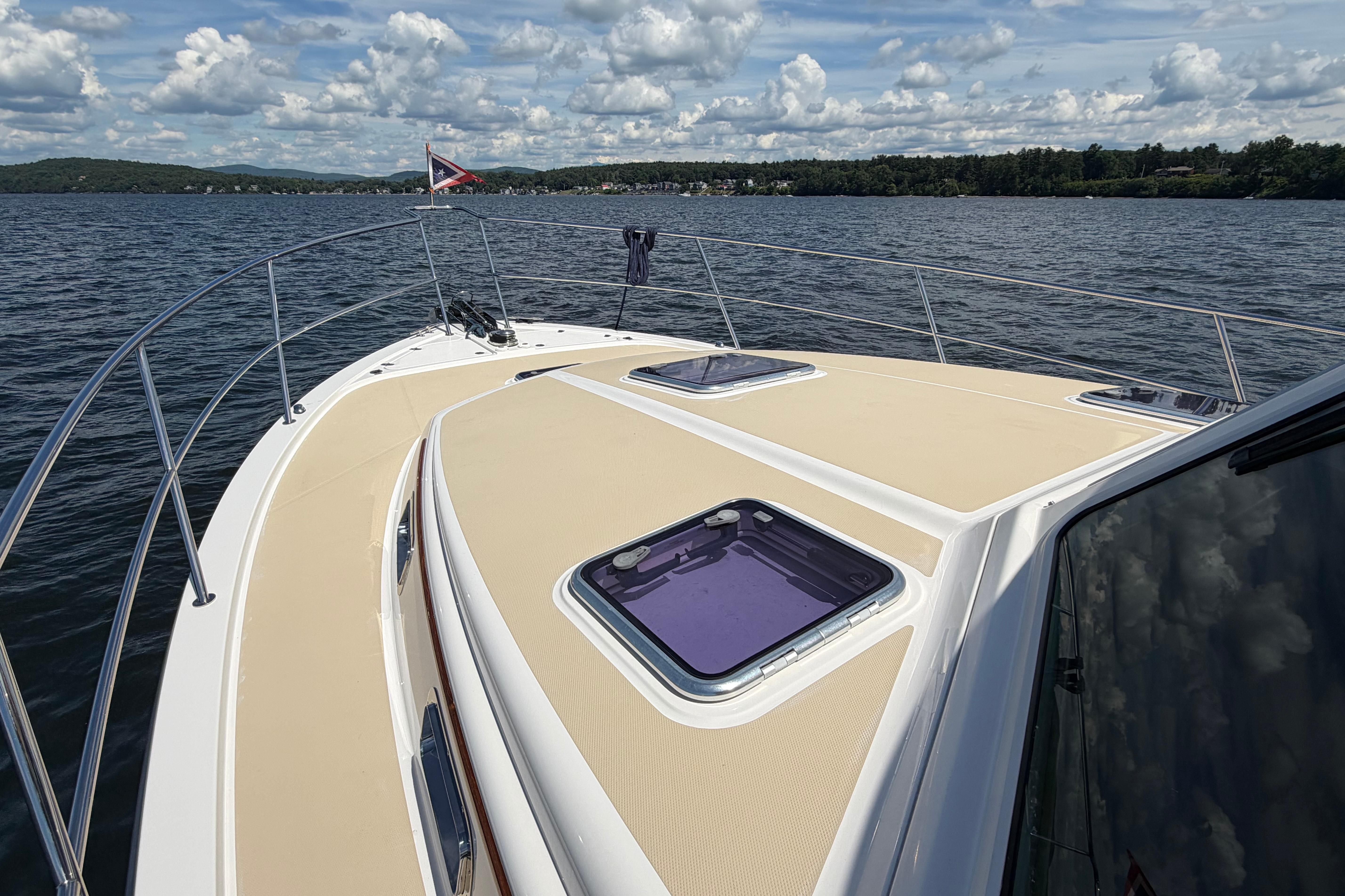 2015 Sabre 38 Salon Express yacht on a lake under a cloudy sky.