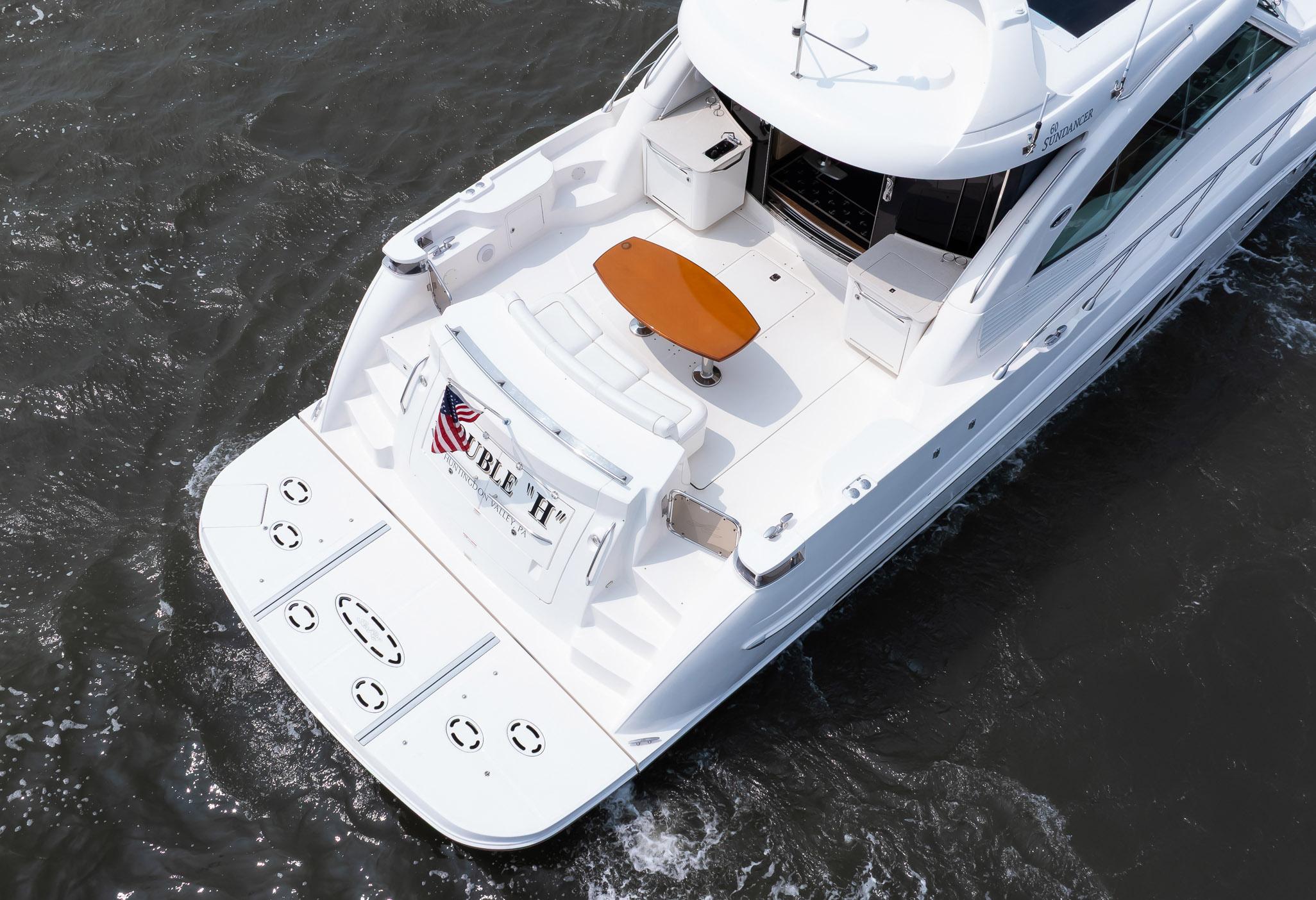 2008 Sea Ray 60 Sundancer yacht on water, rear view with deck and seating area.