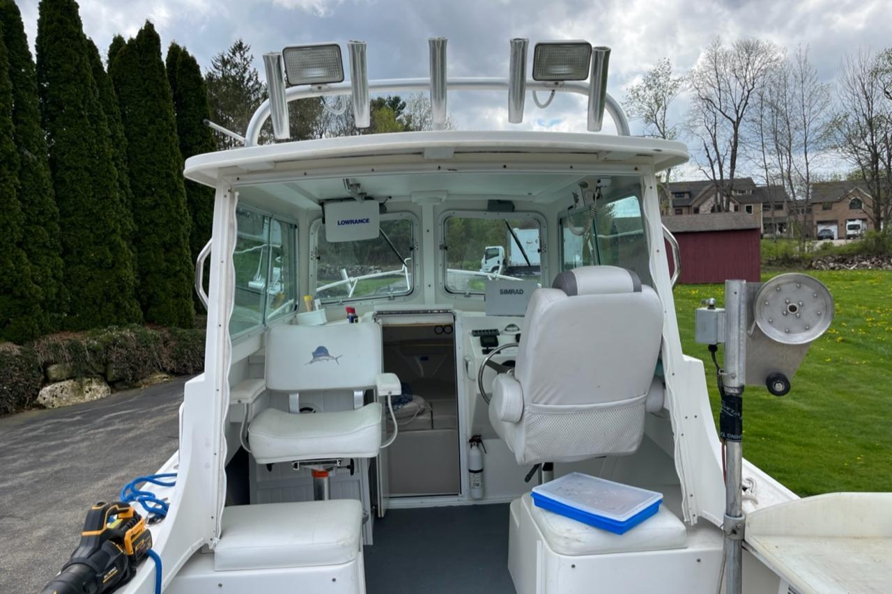 2012 Steiger Craft Miami boat cockpit with seating and navigation equipment.