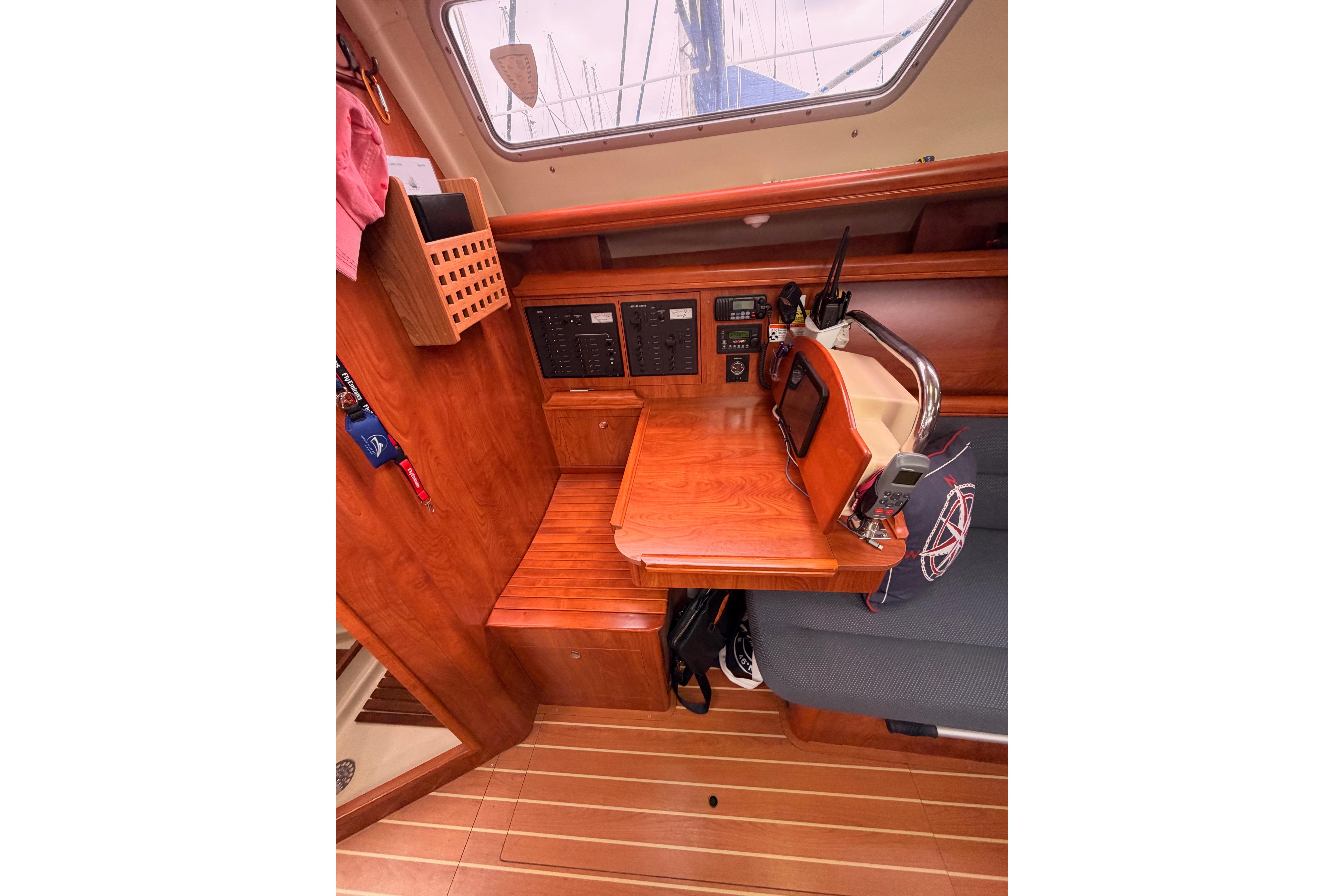 2009 Hunter 38 sailboat interior with navigation station and wooden cabinetry.