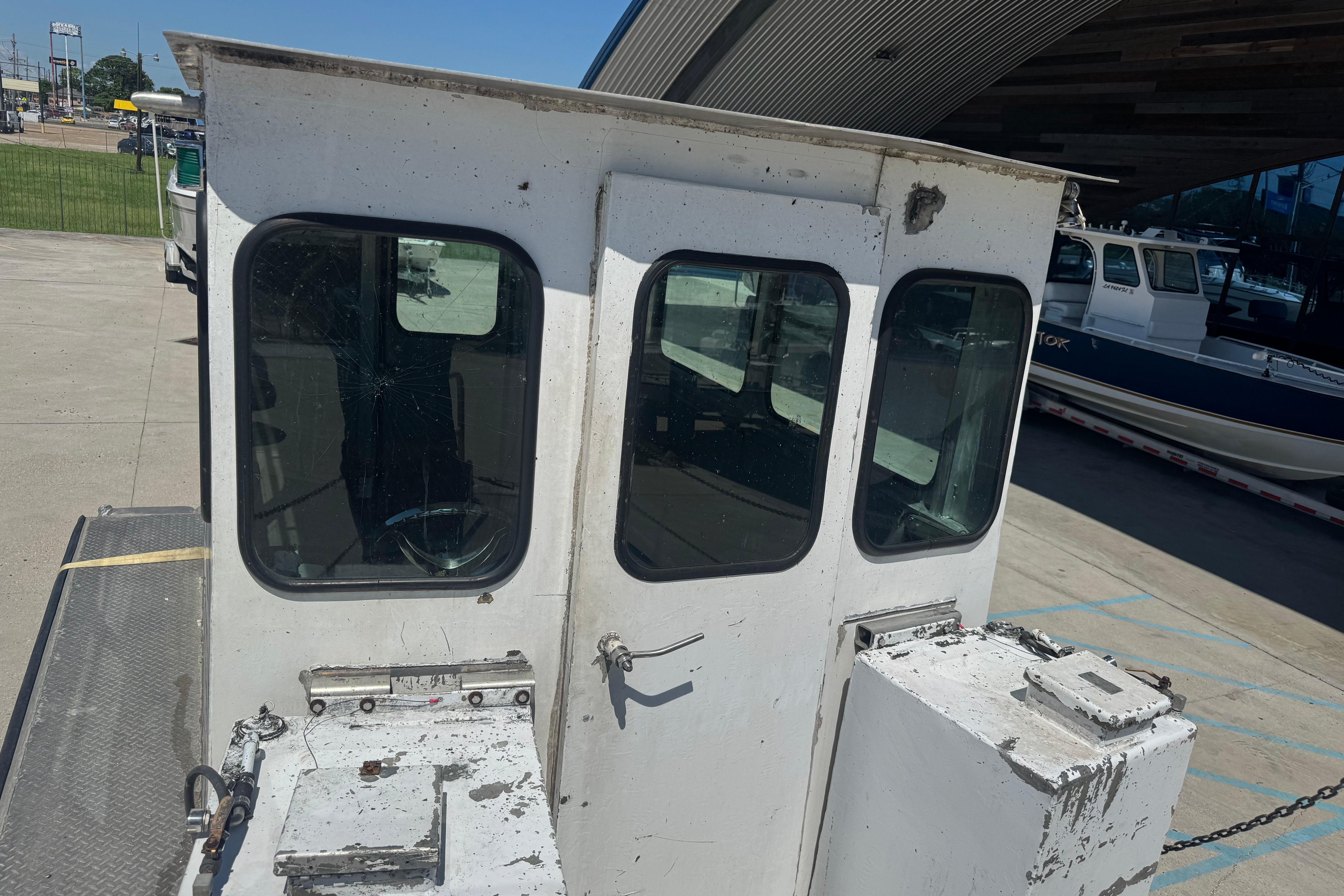 Custom Aluminum Work Boat 33, 2010 model, docked with visible cabin and windows.
