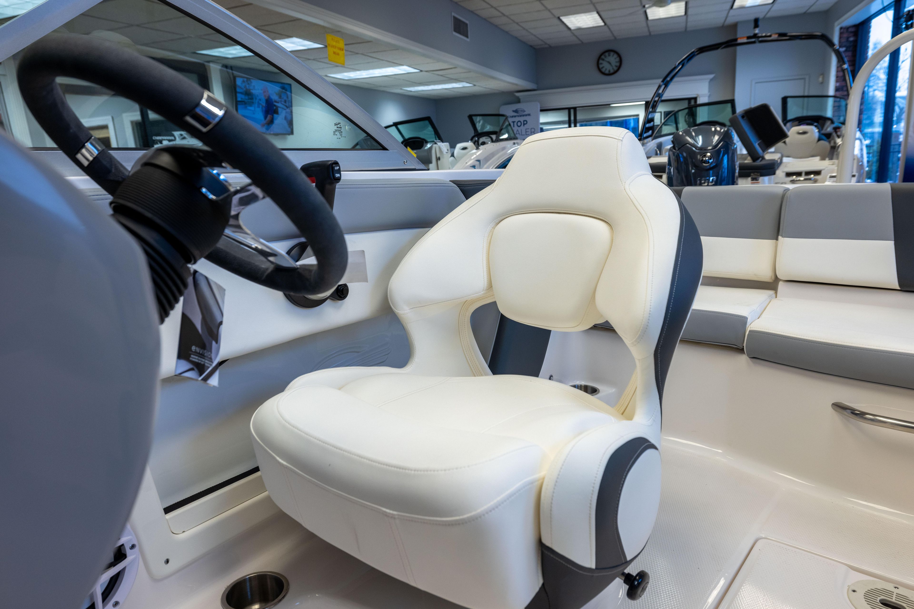 2024 Chaparral 19 SSi OB boat interior with steering wheel and white seating.