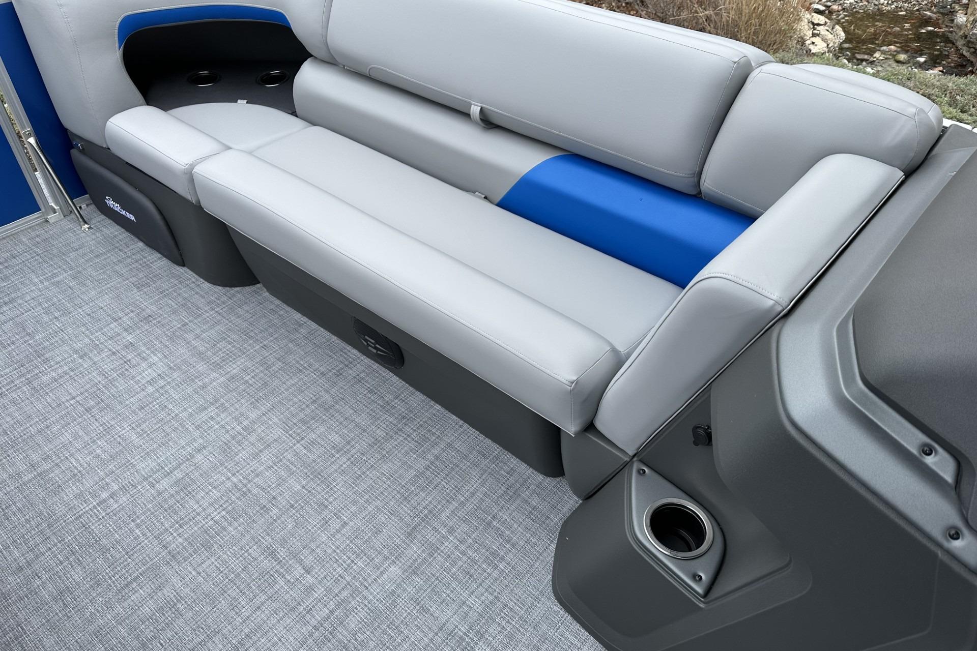 2026 Sun Tracker Party Barge 20 DLX interior with gray and blue seating.
