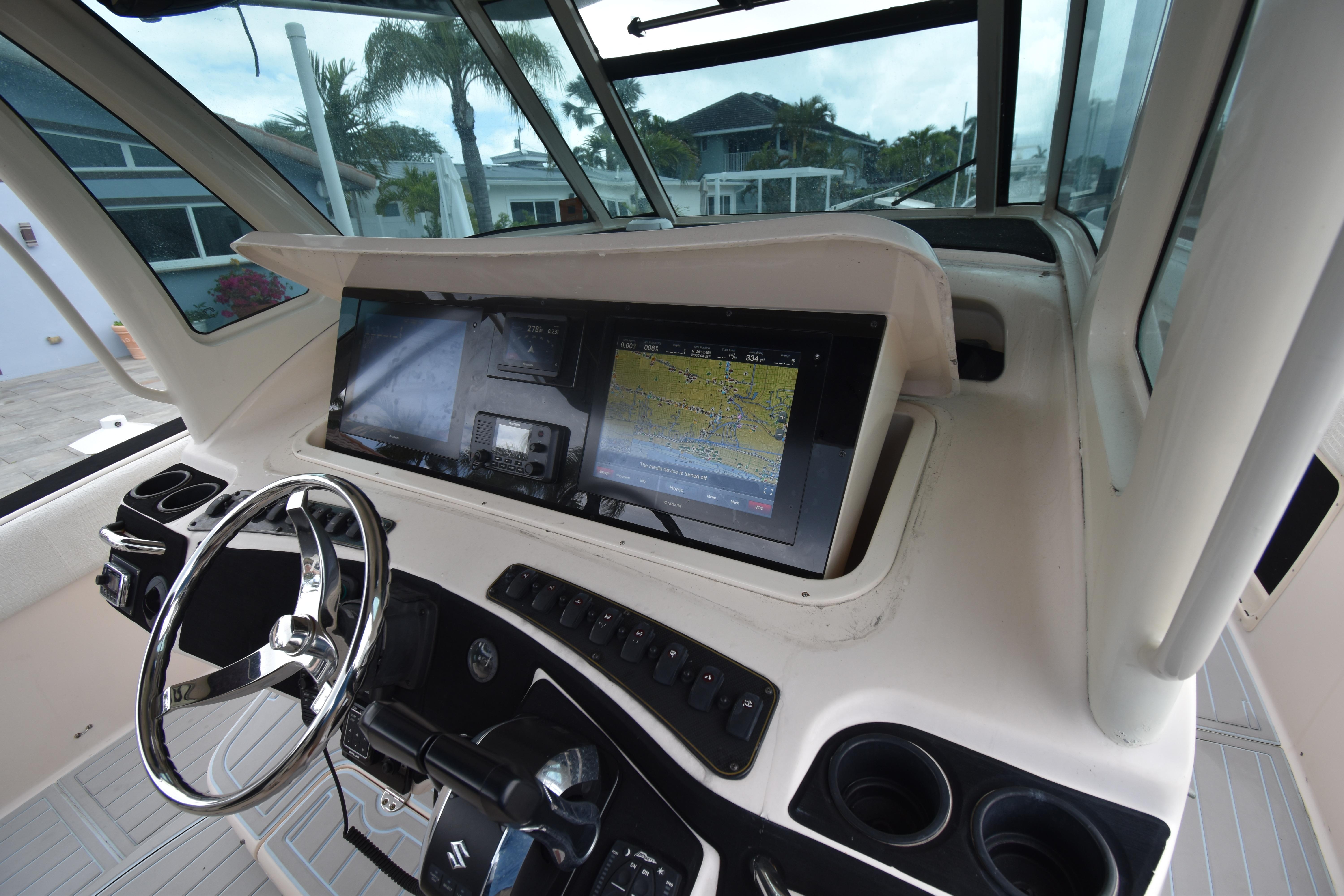 Helm of 2010 Grady-White Canyon 366 with navigation display and steering wheel.