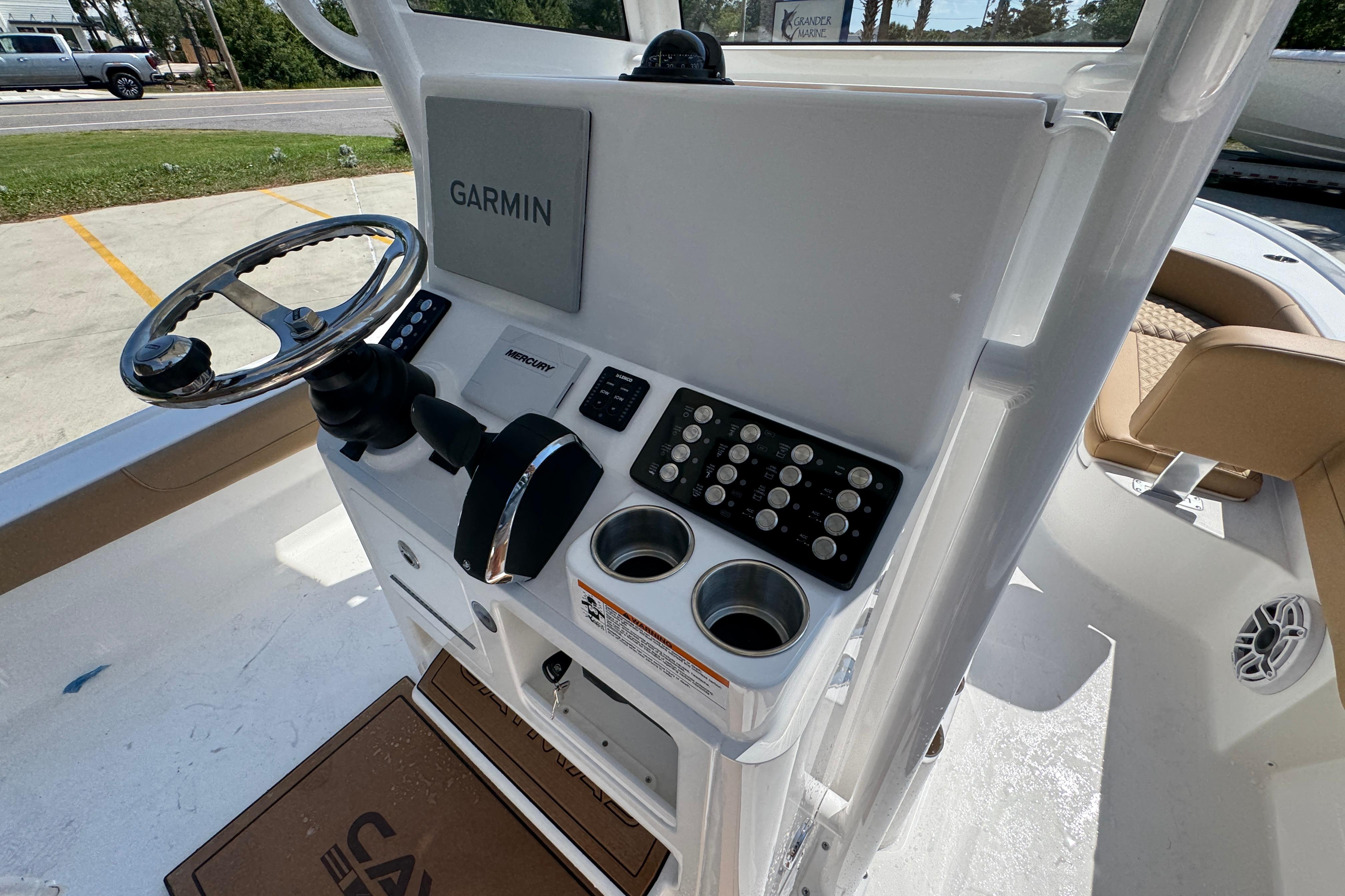 Helm of 2027 Caymas 26 HB boat with Garmin navigation system and Mercury controls.