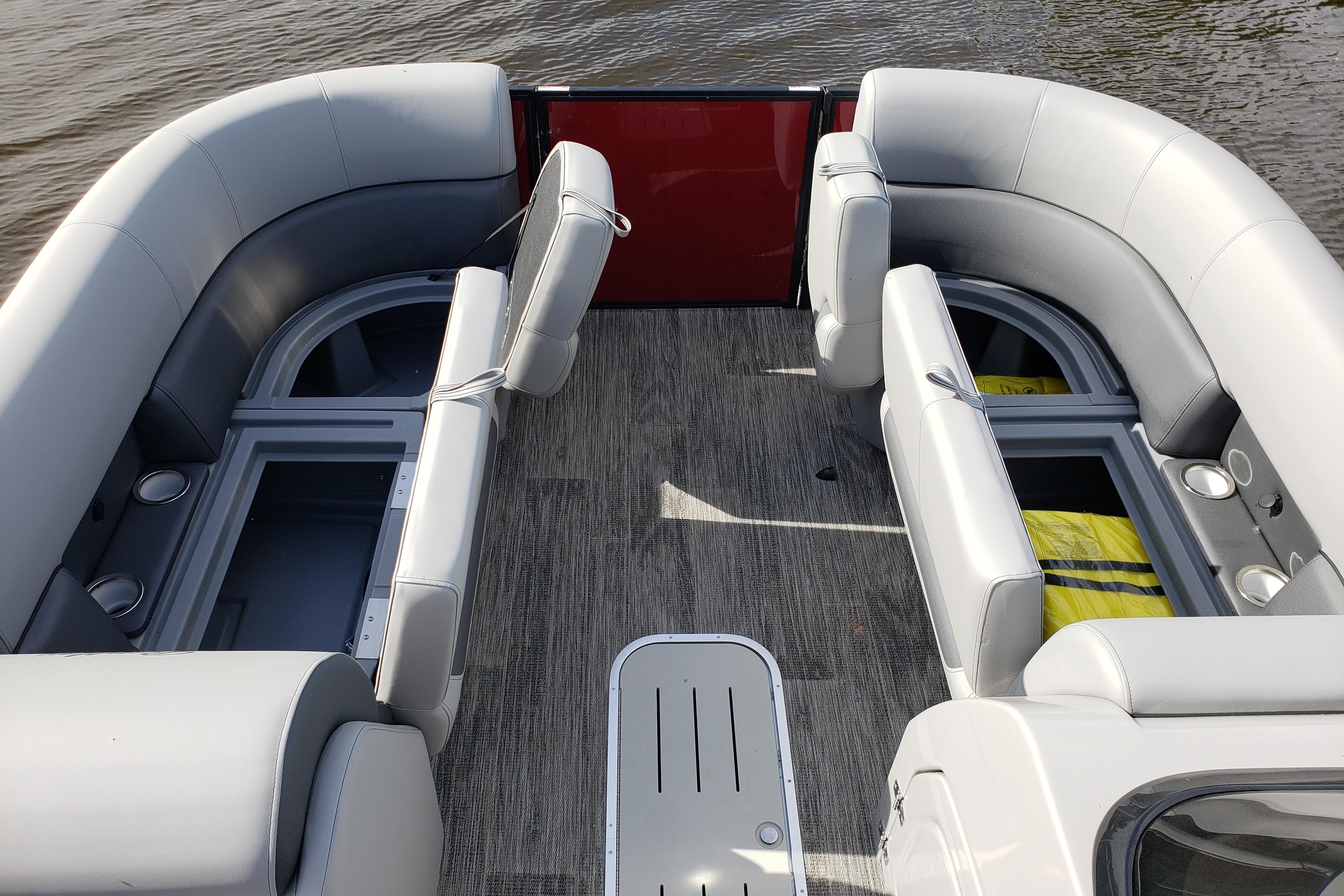 2026 Bentley Pontoons Legacy 243 Navigator Ext interior with gray seating and storage compartments.