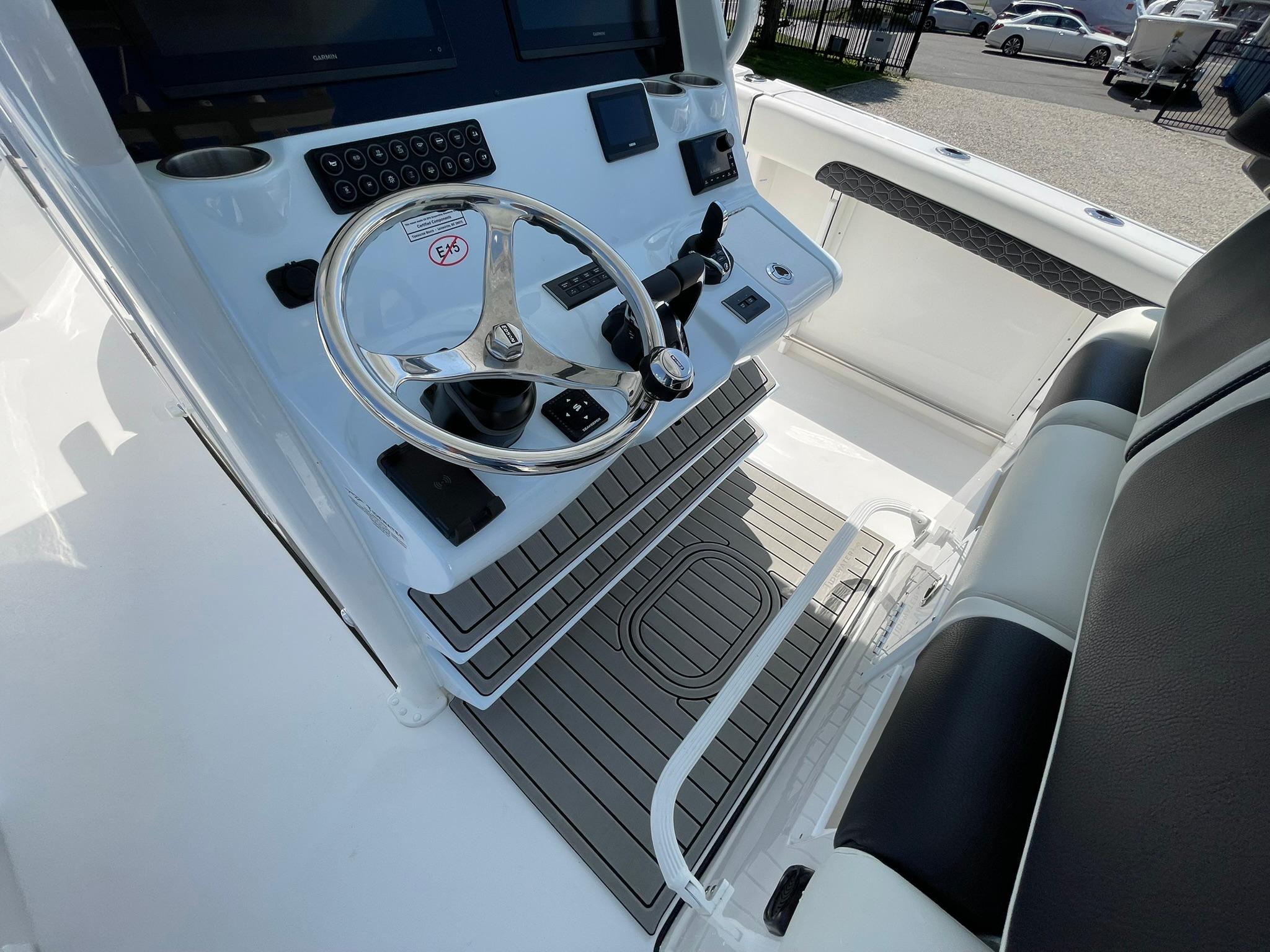 2026 Tidewater 302 CC Adventure boat helm with steering wheel and control panel.