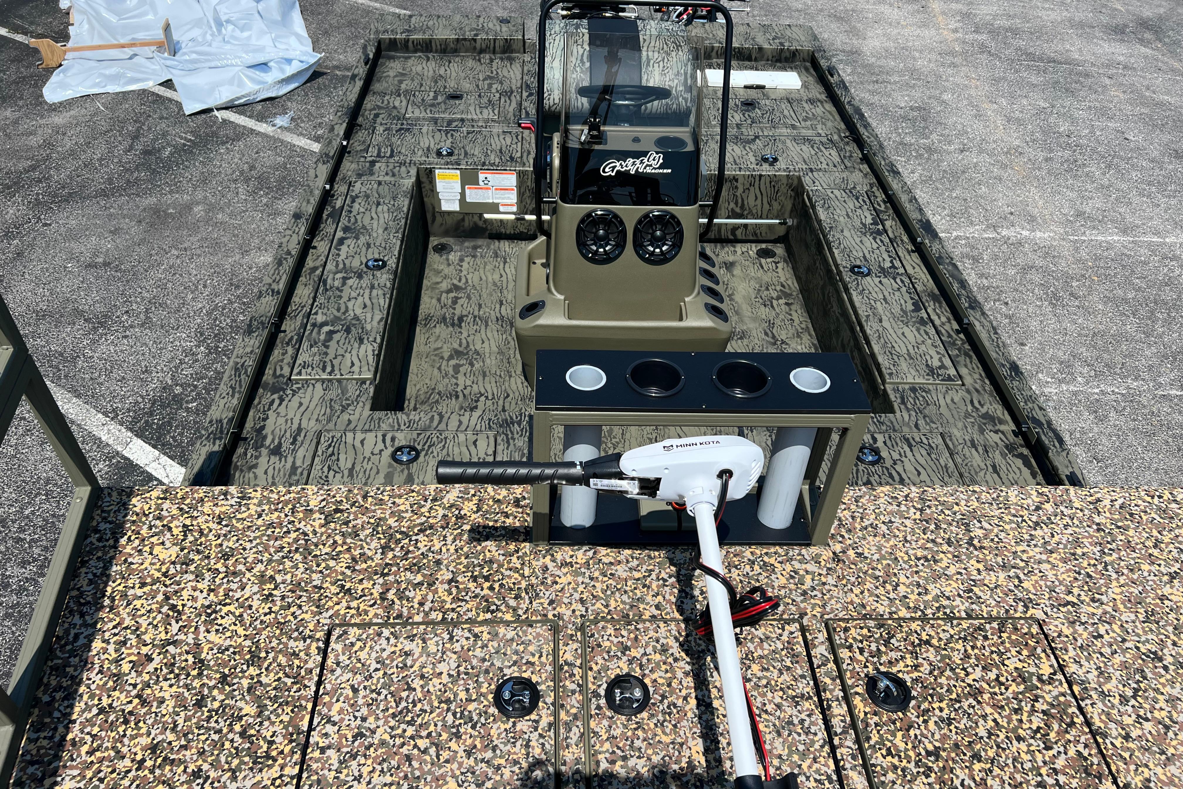 2026 Tracker Grizzly 2072 CC Sportsman Kicker boat interior with control console and trolling motor.