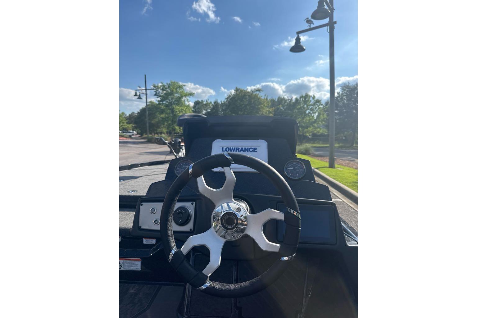 Steering wheel of 2026 Nitro Z21 XL boat with Lowrance display, sunny day background.
